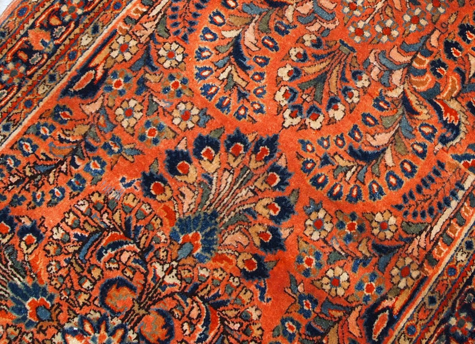 Antique Sarouk rug in original good condition. The rug is from the beginning of 20th century, made in red wool.

 