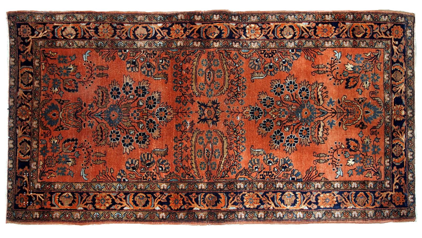 Antique hand knotted Sarouk rug in original good condition. The rug is from the beginning of 20th century in red wool.
 