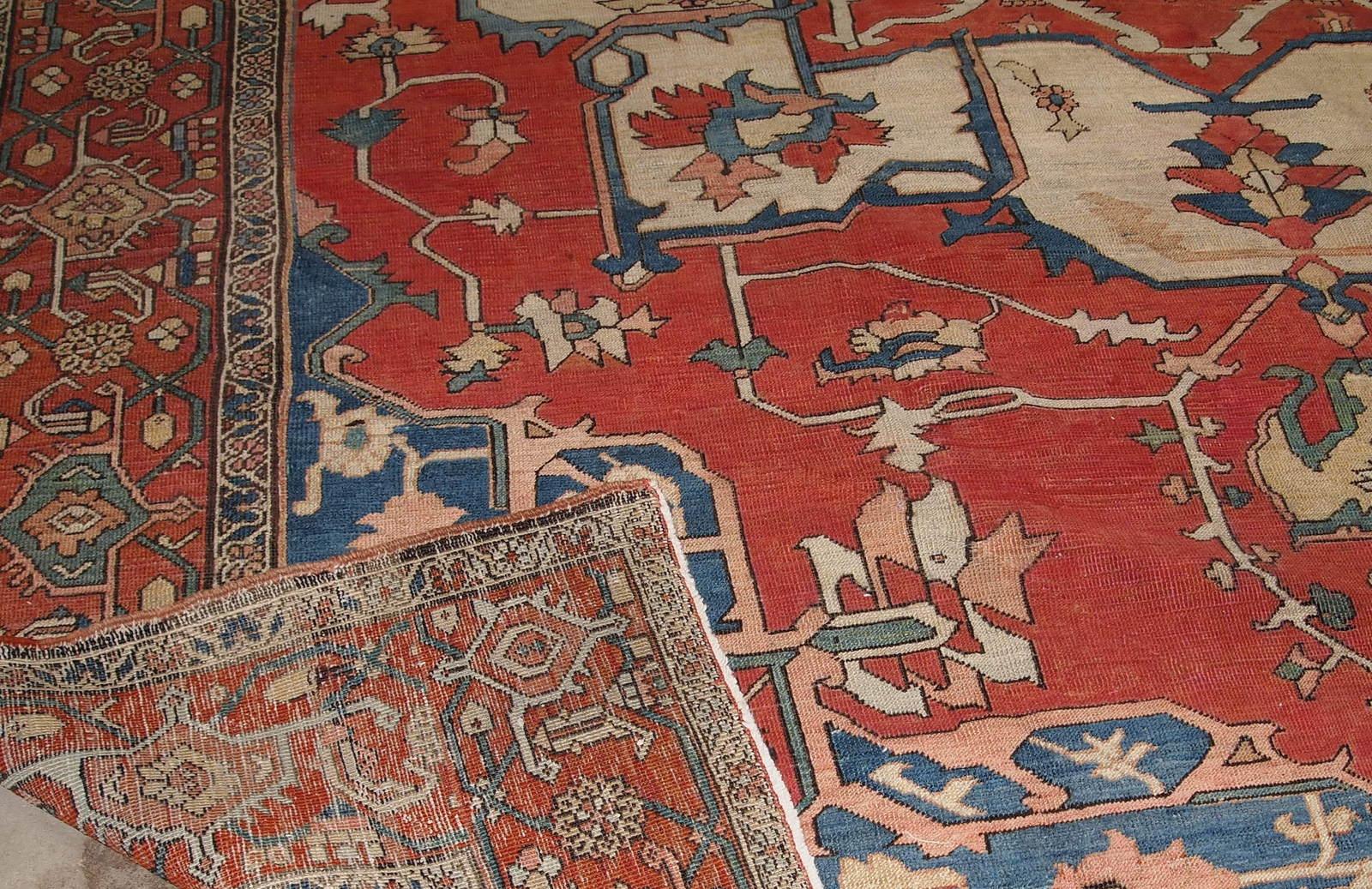 Antique handwoven Serapi rug from the end of 19th century. It is in good condition, made in red, navy blue and sky blue wool.

-condition: good,

-circa: 1880s,

-size: 8.10' x 11.7' (72cm x 356cm),

-material: wool,

-country of origin: