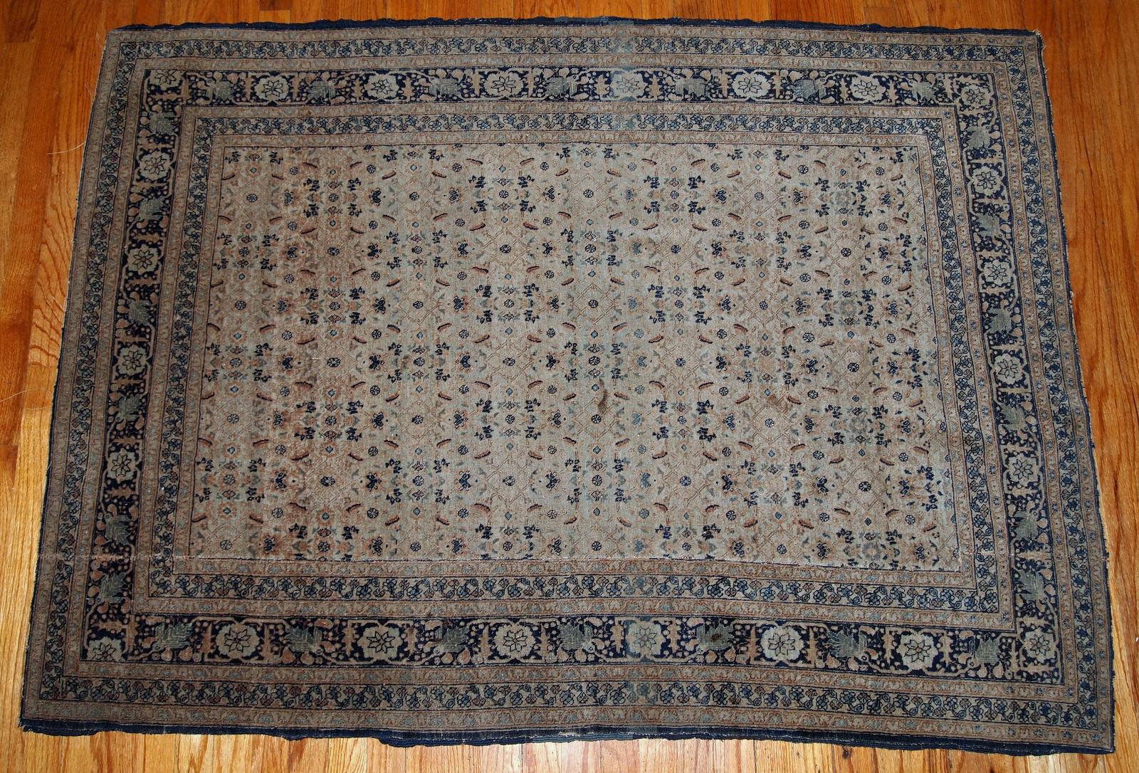 Antique tabriz hajalili rug in beige, brown and blue wool. The rug is from the end of 19th century, it has one cut.

 
