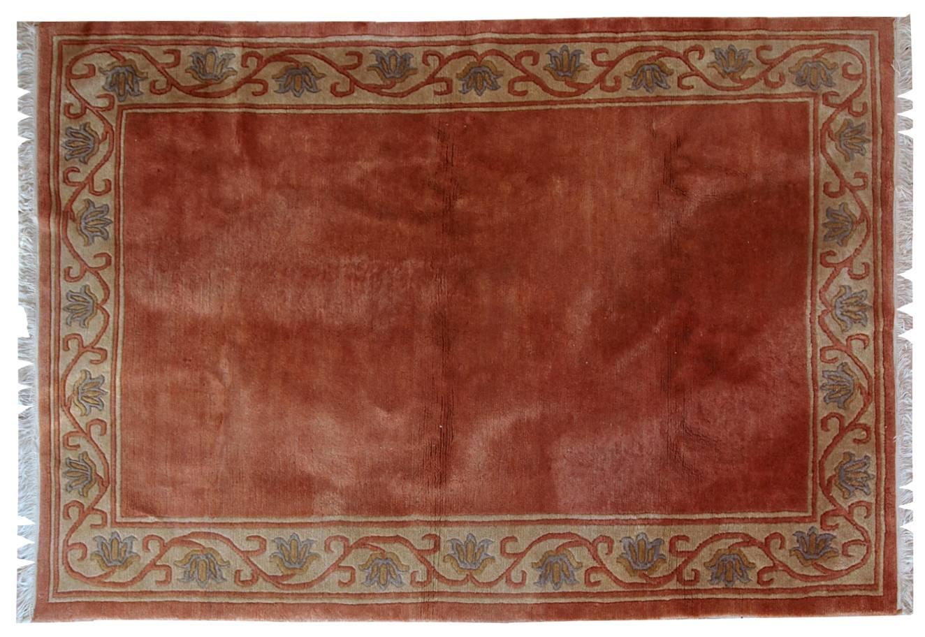 Handmade vintage Tibetan rug from Nepal in pink shade, decorative border and with all-over design. The rug has very soft wool, it is thick and warm. There no damages, it is in original good condition.
 