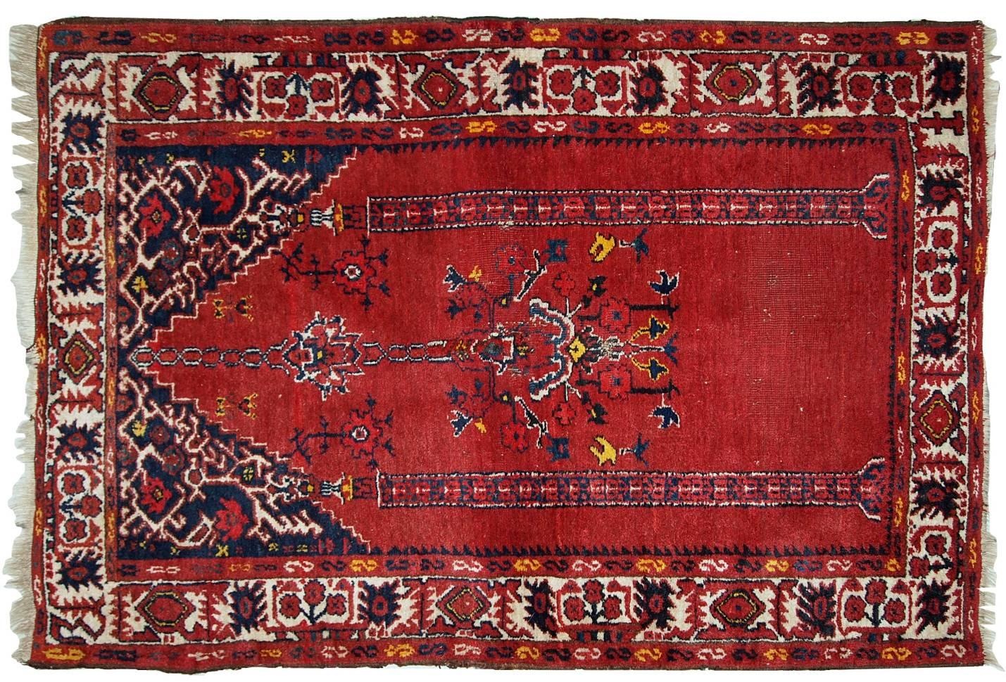 Vintage handmade Turkish prayer rug in bright red shade with yellow, white and navy blue details. The rug is in original condition, it has some low pile. Made out of soft wool.
 