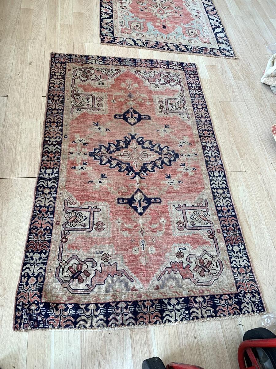 This handmade antique Turkish Anatolian rug from the 1920s showcases a timeless blend of geometric medallions and intricate floral motifs, making it a striking statement piece for any interior. Its traditional color palette and delicate