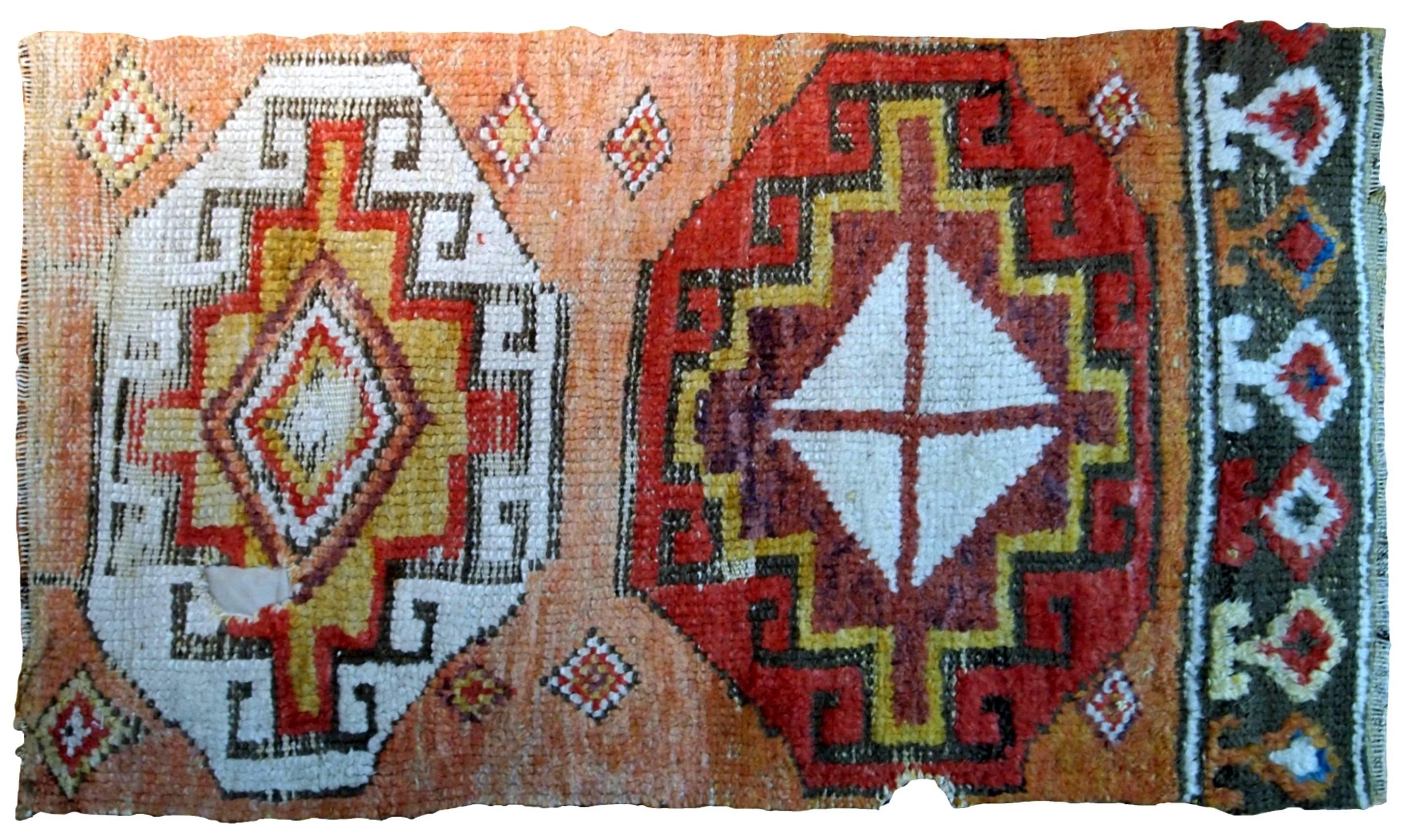 Handmade antique Turkish Konya fragment from the middle of 18th century. Nice salmon shade of the background with red and white diamond shaped medallions. Has some age wear and one hole.
 