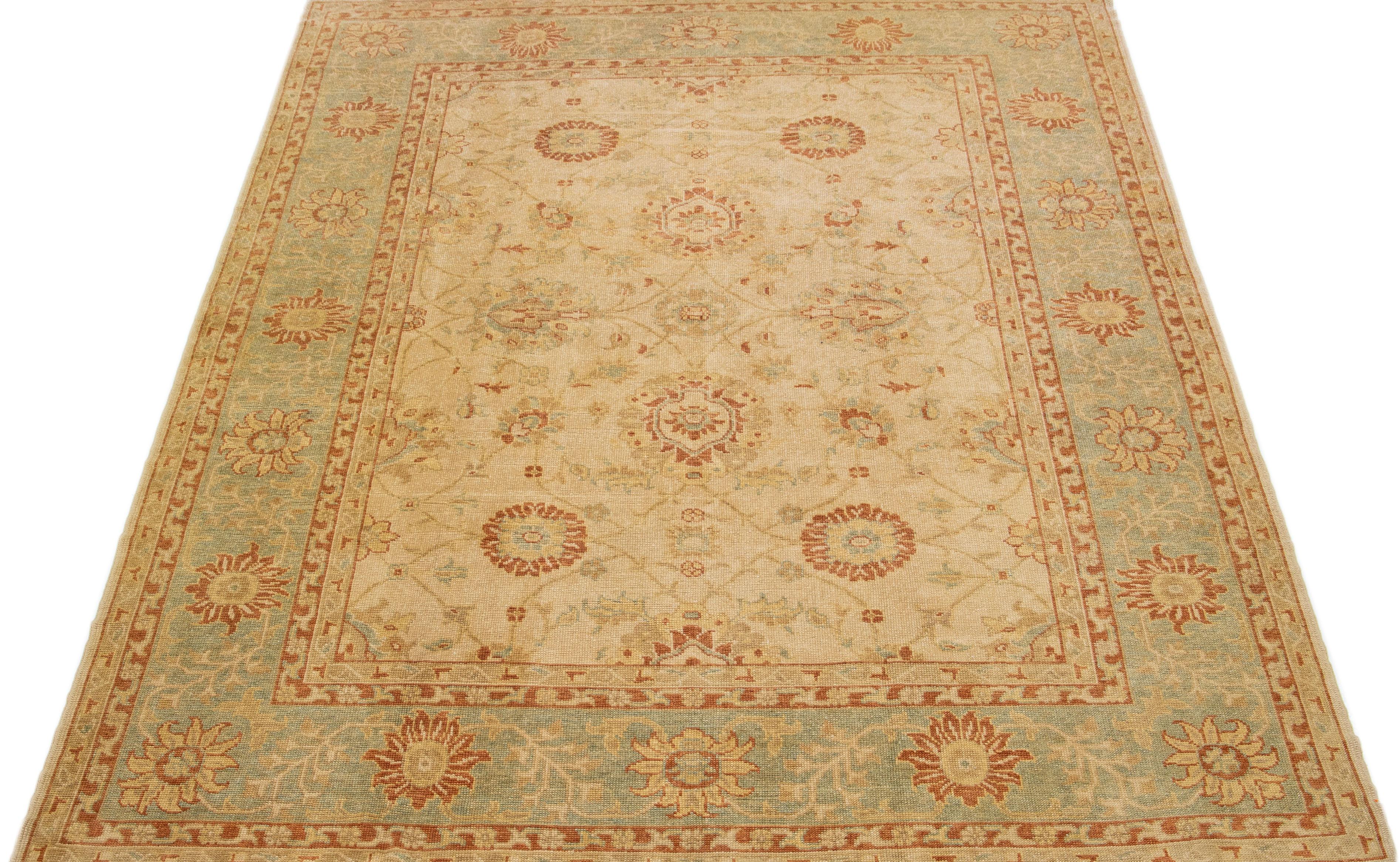 This modern Turkish wool rug boasts a tan field, beautifully framed with blue, rust, and goldenrod highlights in an intricate all-over floral pattern.

This rug measures: 9'5