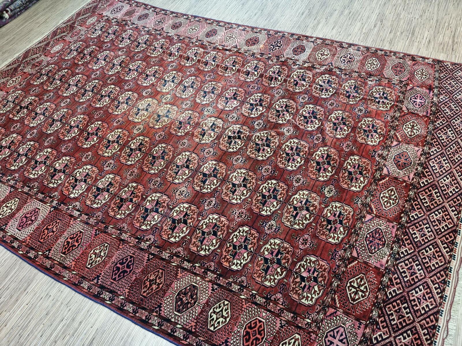 Embrace the history and culture of Turkmenistan with this Handmade Antique Turkmen Tekke Rug. This stunning rug measures at 7.5’ x 11.6’ (230cm x 355cm), making it a great addition to any room.

Color Palette: The rug features a vibrant red field
