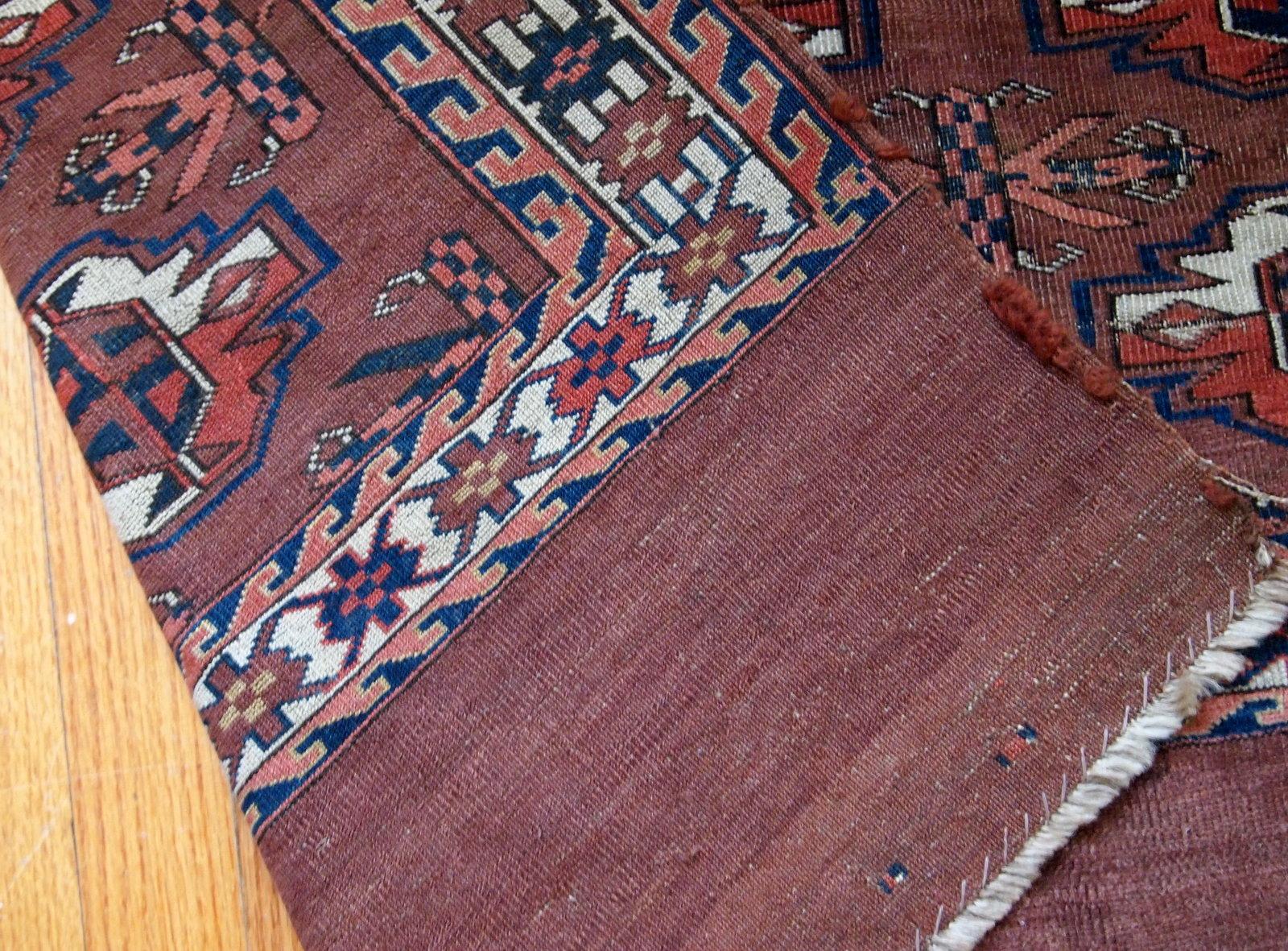 Handmade antique collectible Turkmen Yomud rug in original condition with some signs of age.
  
