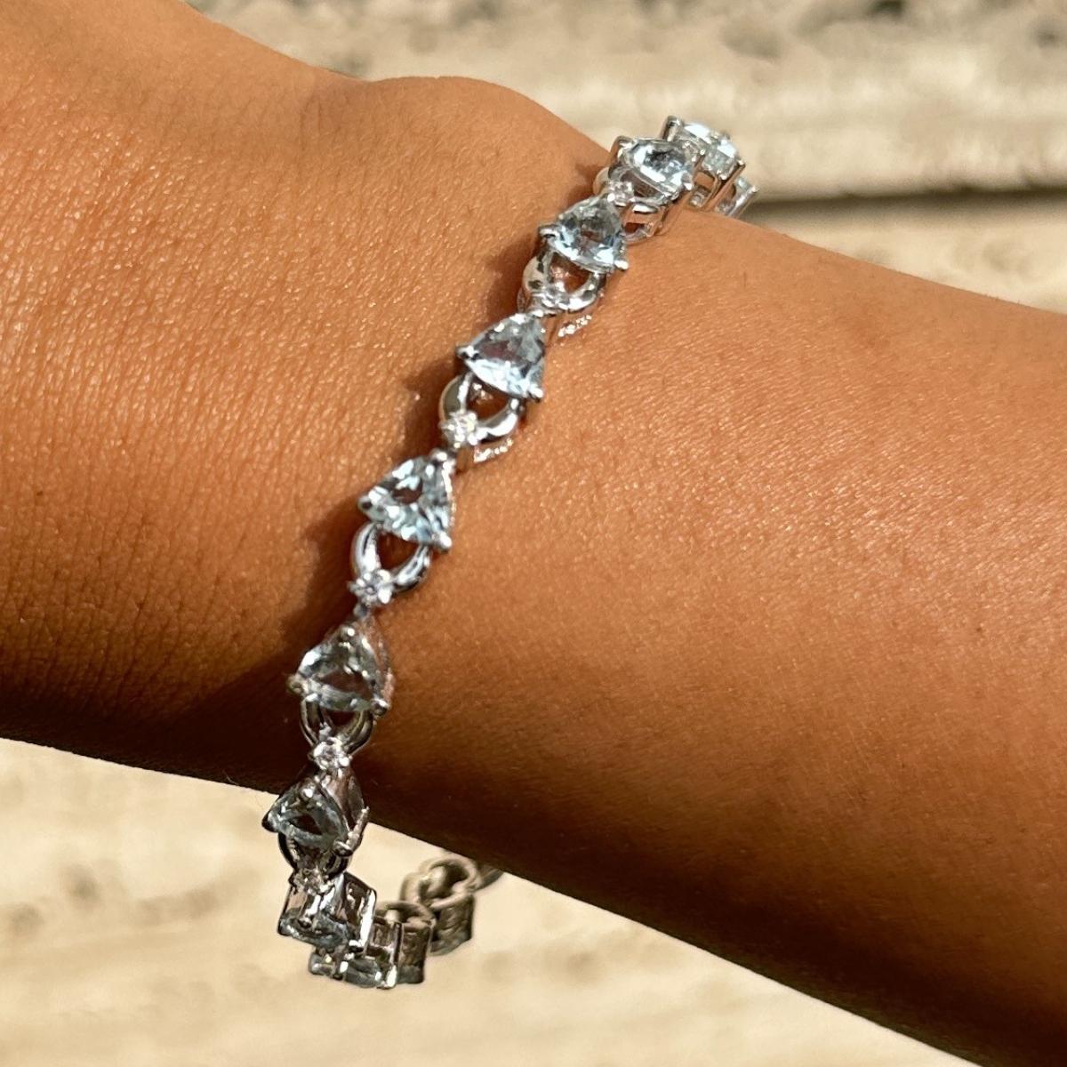 Handmade Aquamarine Zircon Bracelet in sterling silver showcases endlessly sparkling natural aquamarine, weighing 10.42 carat. It measures 7 inches long in length. 
Aquamarine stimulate concentration and reduces stress. 
Designed with perfect