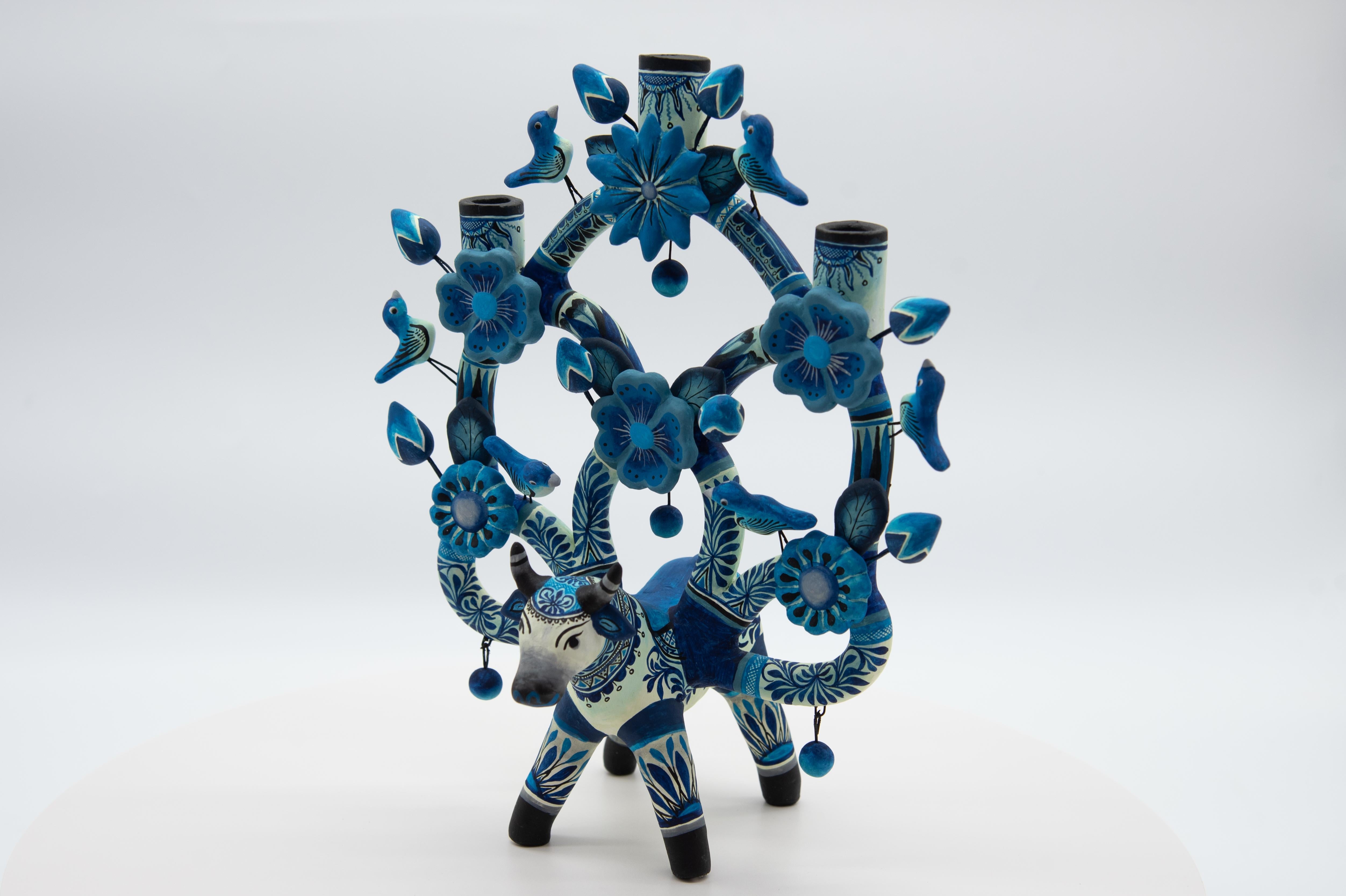 Discover this stunning piece of Mexican folk art: an Árbol de la Vida in the shape of a bull, meticulously handcrafted in clay and hand-painted with vibrant acrylic colors. This unique artwork is created by renowned artisan Soledad Martha Hernández