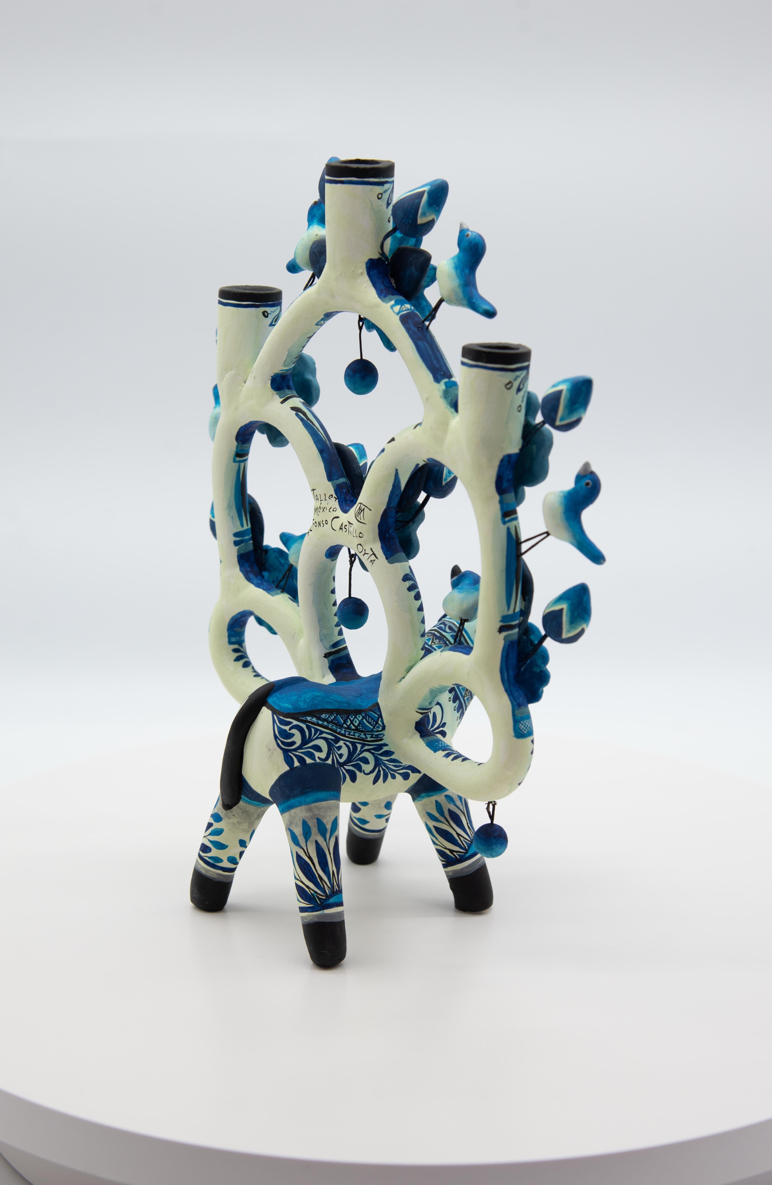 Découvrez cette étonnante pièce d'art populaire mexicain : un Árbol de la Vida en forme de taureau, méticuleusement réalisé en argile et peint à la main avec des couleurs acryliques vibrantes. Cette œuvre d'art unique est créée par la célèbre
