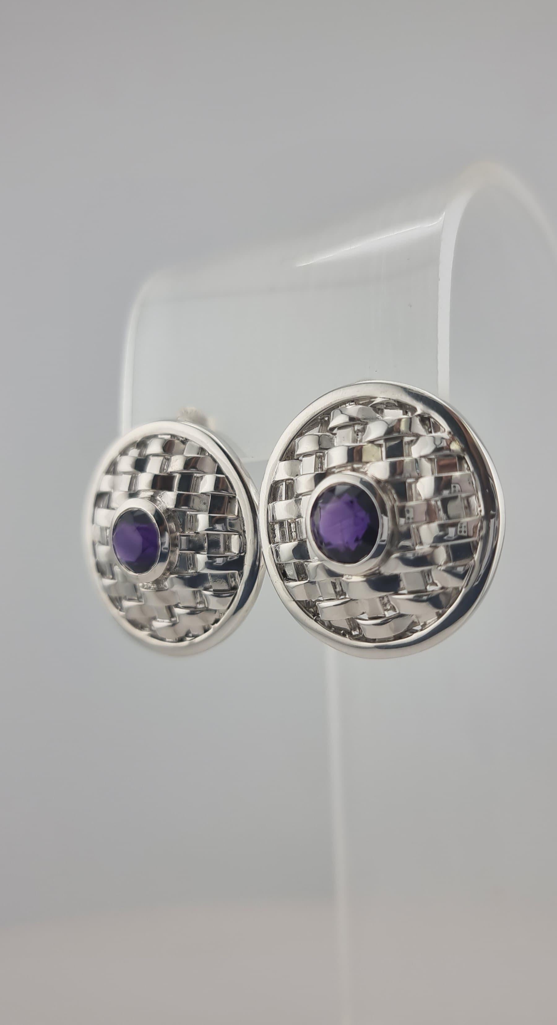 Discover the beauty of Lesotho's cultural heritage with our Round Amethyst Basket Rhodium Sterling Silver Stud Earrings. Inspired by the intricate weaving of the Basotho basket, these exquisite earrings showcase the timeless elegance of amethyst and
