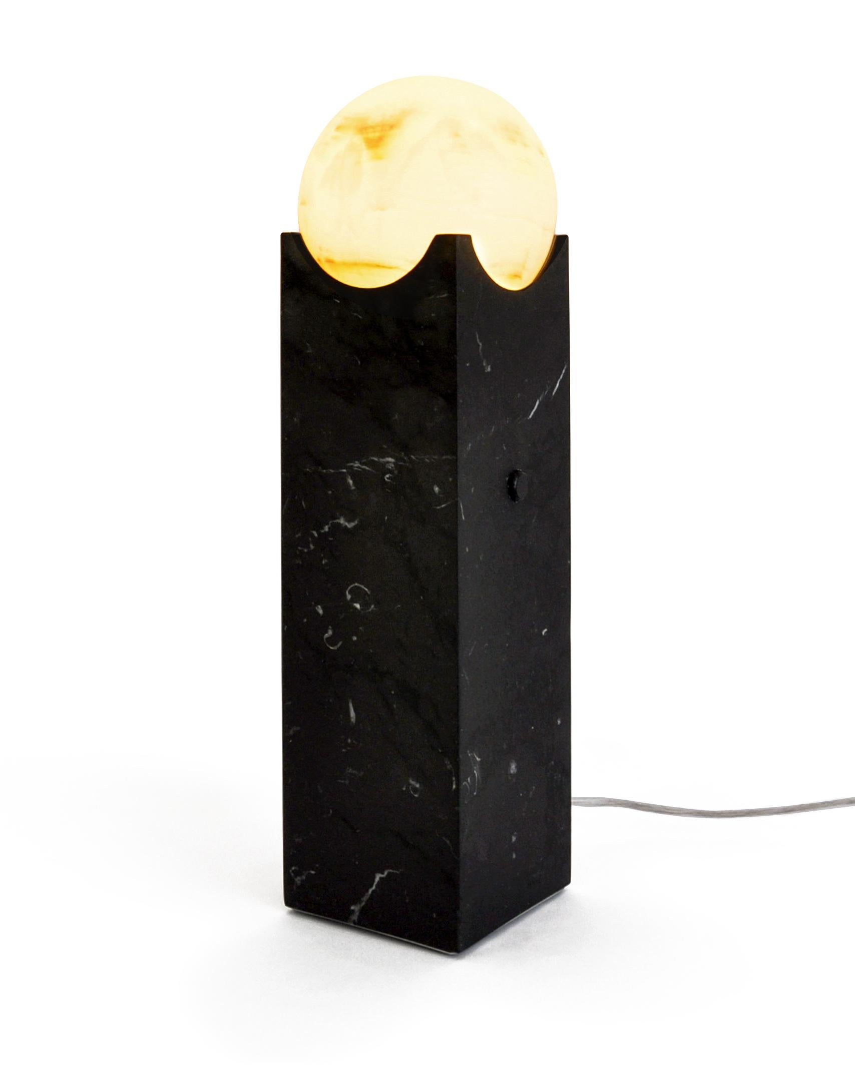 Big eclipse lamp in satin Paonazzo or black Marquina marble. It gives a distinct and elegant touch to your house.

Each piece is in a way unique (every marble block is different in veins and shades) and handmade by Italian artisans specialized over