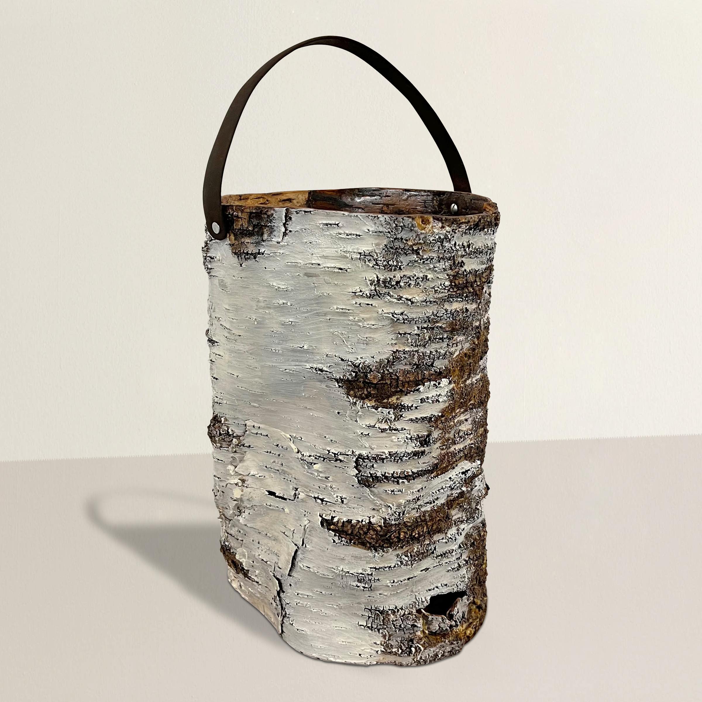 Indulge in the rustic elegance of this handmade birch bark bucket, discovered in the heart of Wisconsin. Inspired by the time-honored traditions of Native American basketry in the region, this exquisite piece seamlessly blends history with modern