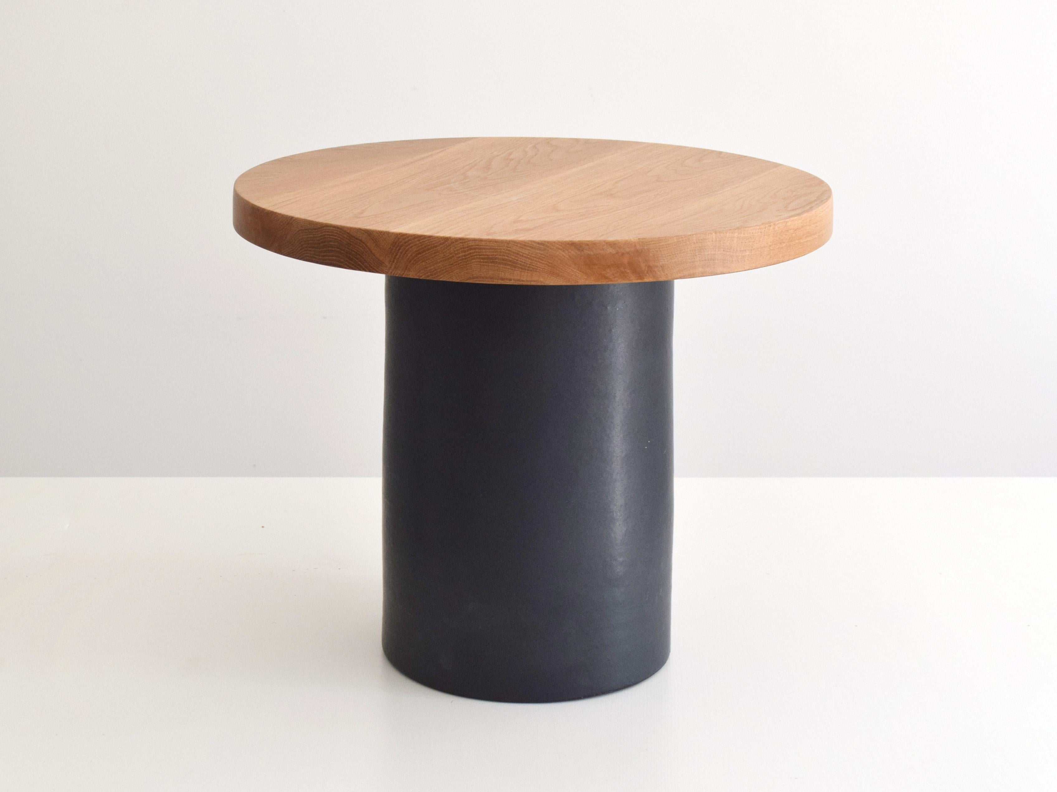 This handcrafted coffee table combines a sculptural ceramic base with a solid oak top, balancing artisanal craftsmanship with modern design. Designed for use as a side table or compact coffee table, it works beautifully in contemporary interiors