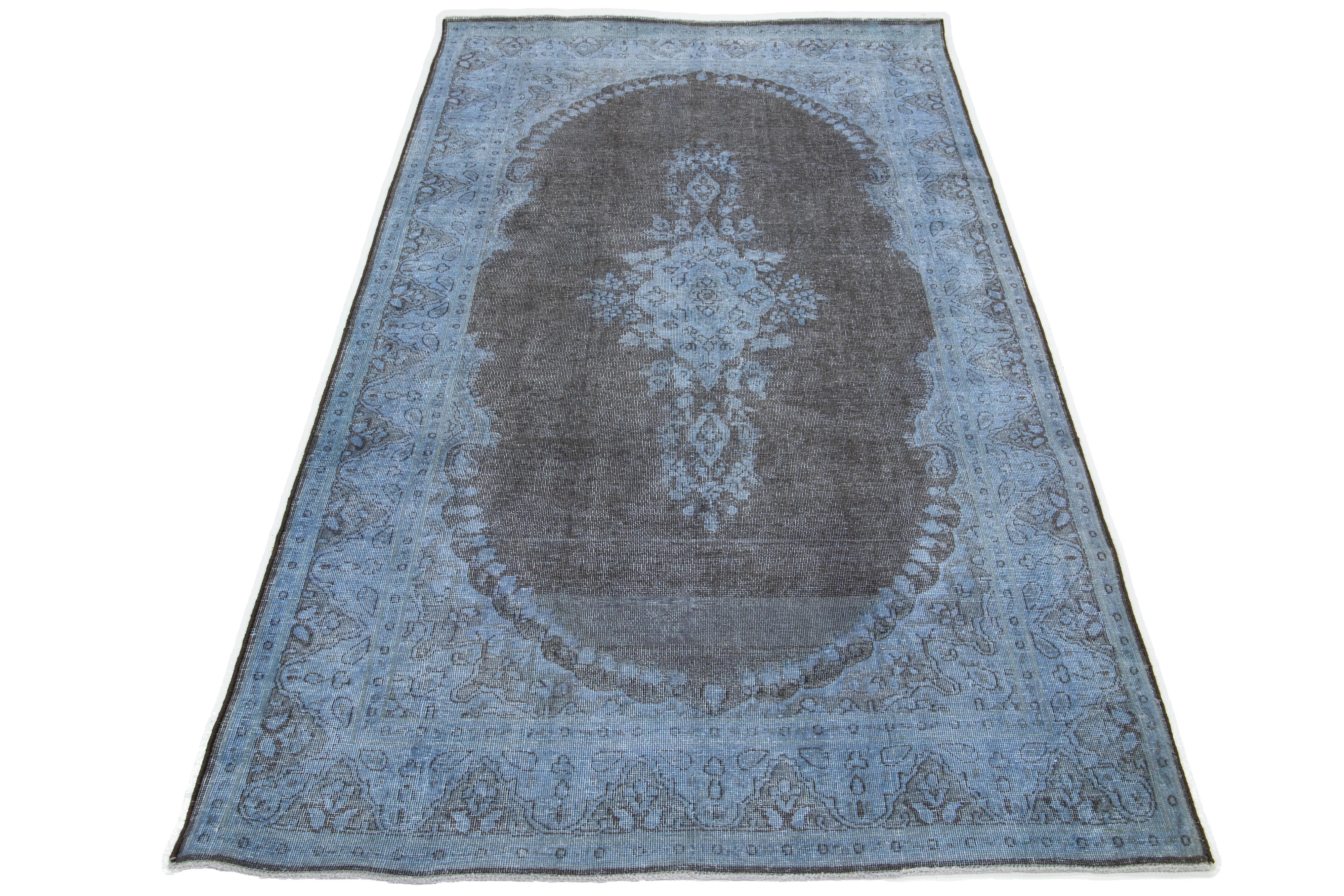 This vintage overdyed Persian wool rug features a captivating blue field with charming gray floral accents.

This rug measures 3'11