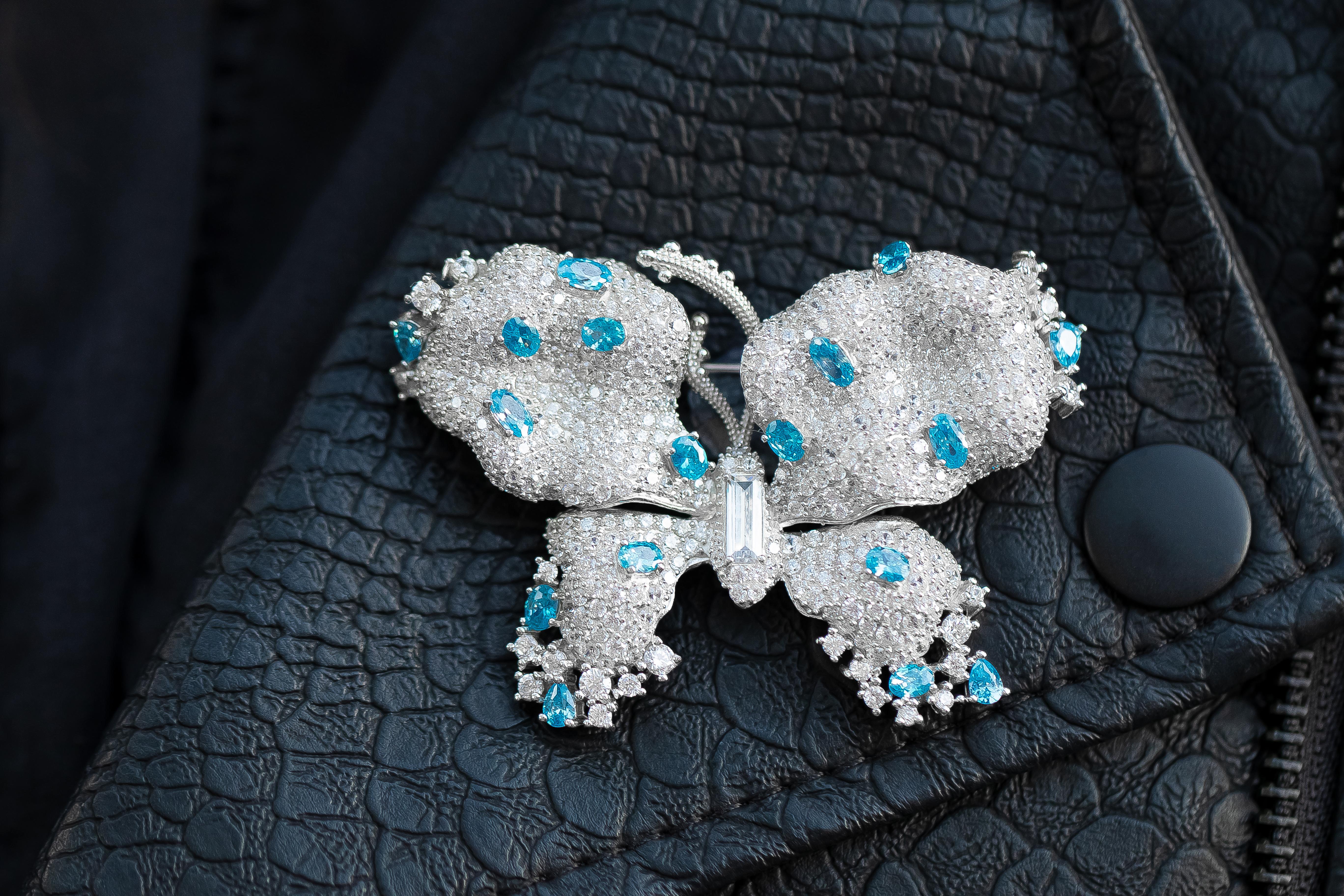 With its soft tones of blue, this butterfly pin adds a touch of fun to any outfit. Each piece is carefully fashioned from sterling silver and blue & white cubic zirconia stones. Perfect Valentine's day, Birthday or Anniversary present.

Hand Made