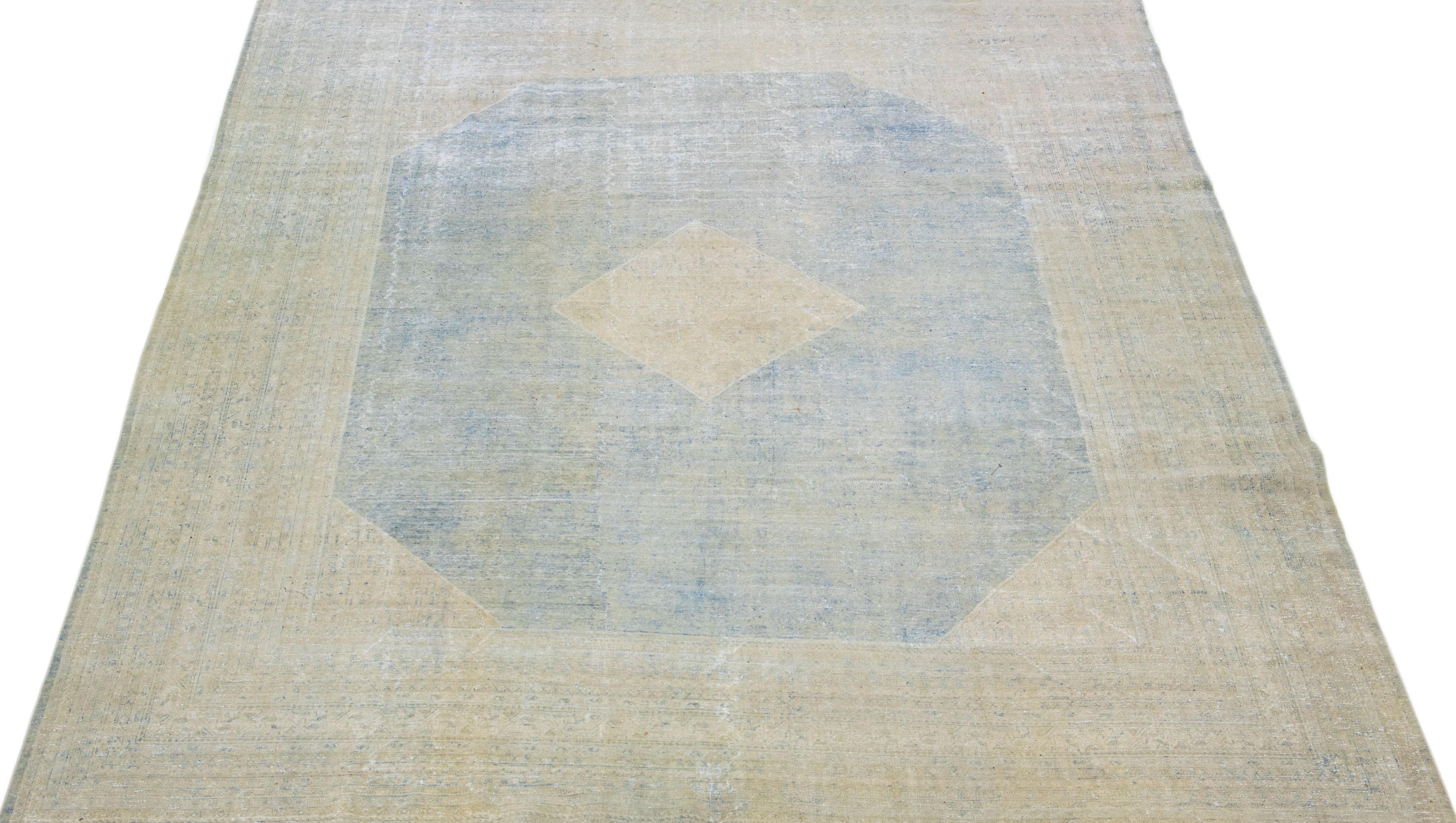 Beautiful hand-knotted antique mahal wool rug with a blue field. This Persian rug has beige accent colors in a medallion design. 

This rug measures: 9'10