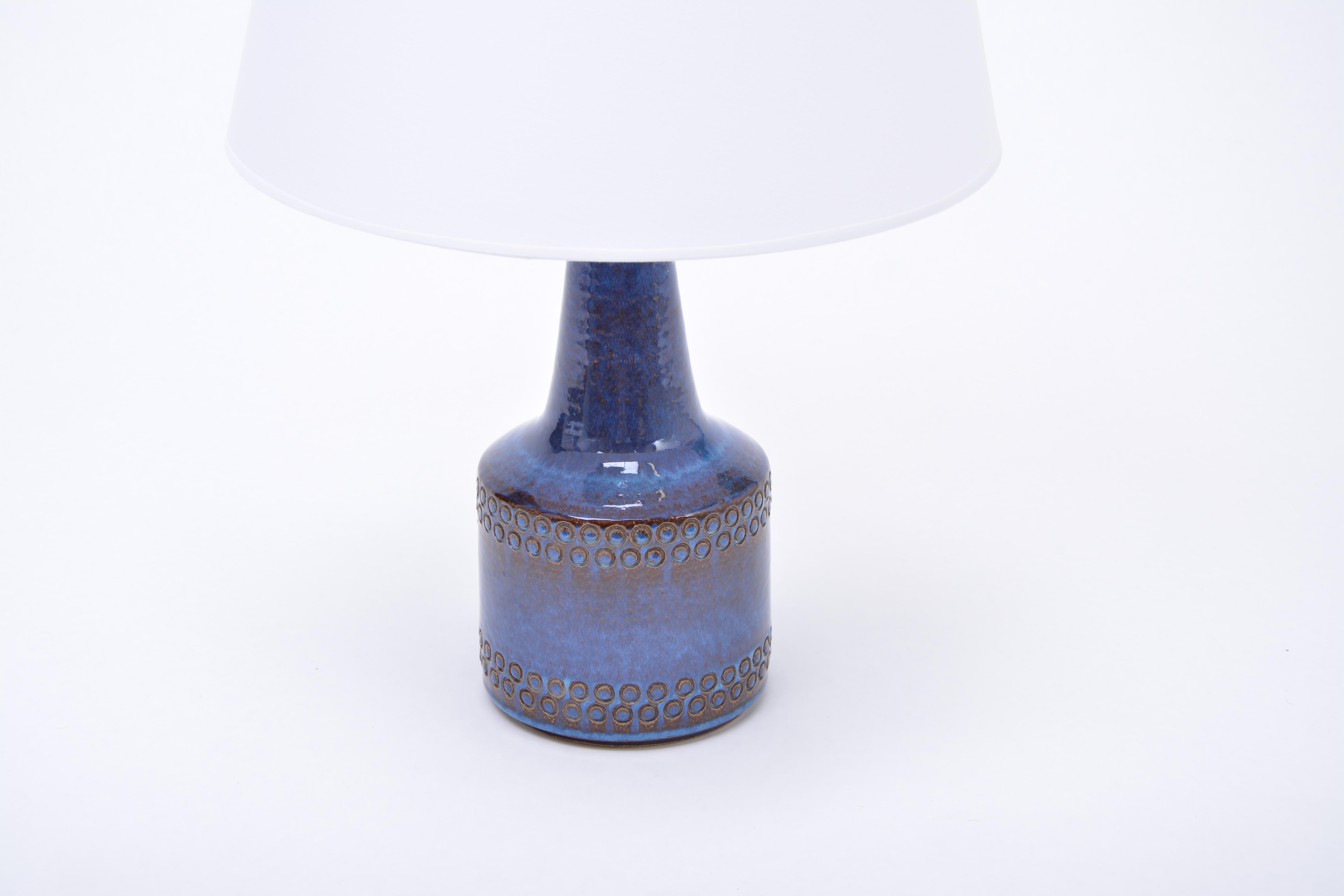 Handmade Blue Danish Mid-Century Modern Stoneware table lamp by Soholm

Table lamp made of stoneware with ceramic glazing in different tones of blue. Circular pattern to the base of the lamp. Produced by Danish company Soholm. The lamp has been