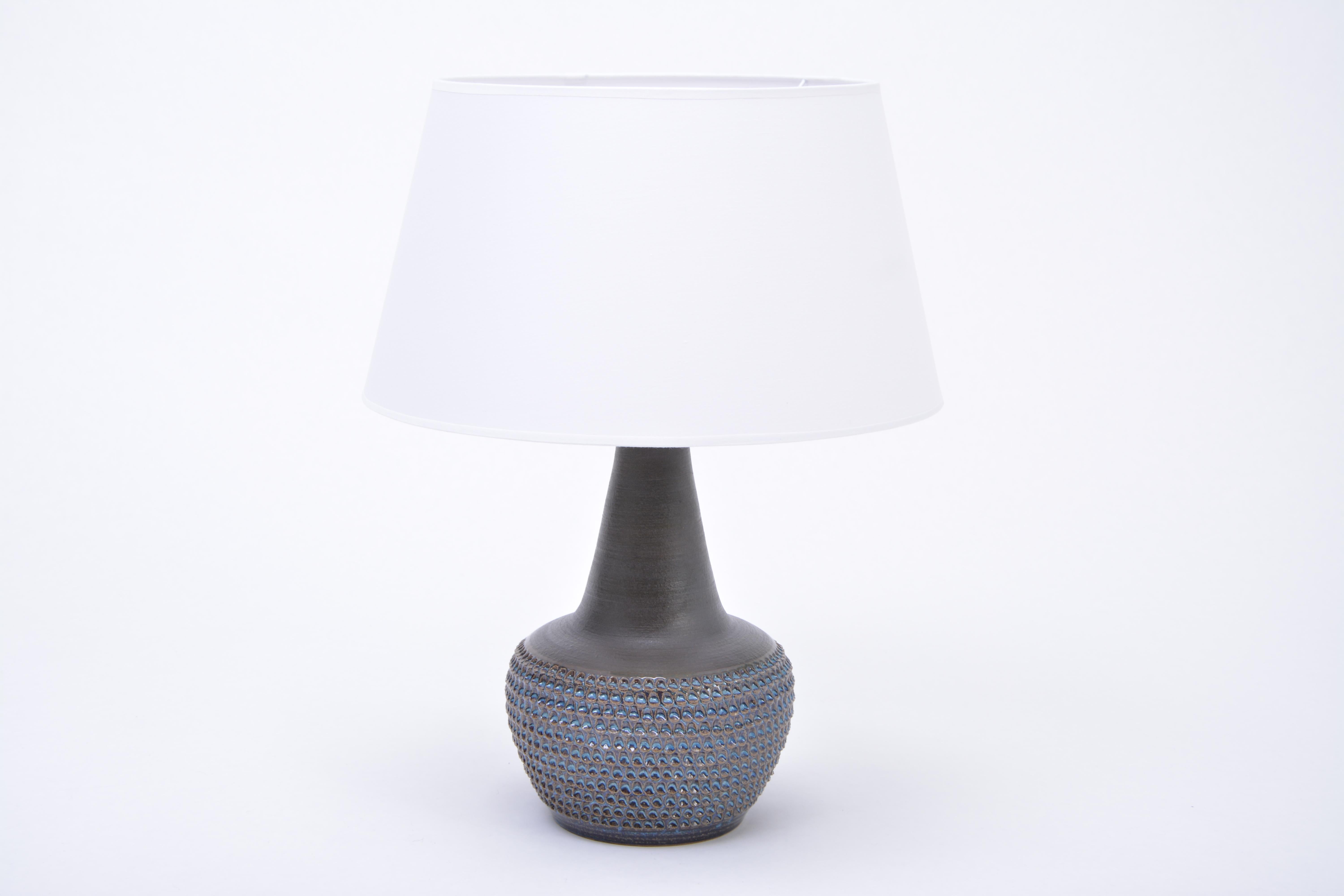 Handmade Blue Danish Mid-Century Stoneware lamp Model 3048 by Soholm
Stunning table lamp handmade of stoneware with ceramic glazing in different tones of blue. Circular pattern to the base of the lamp. Produced by Danish company Soholm. The lamp has