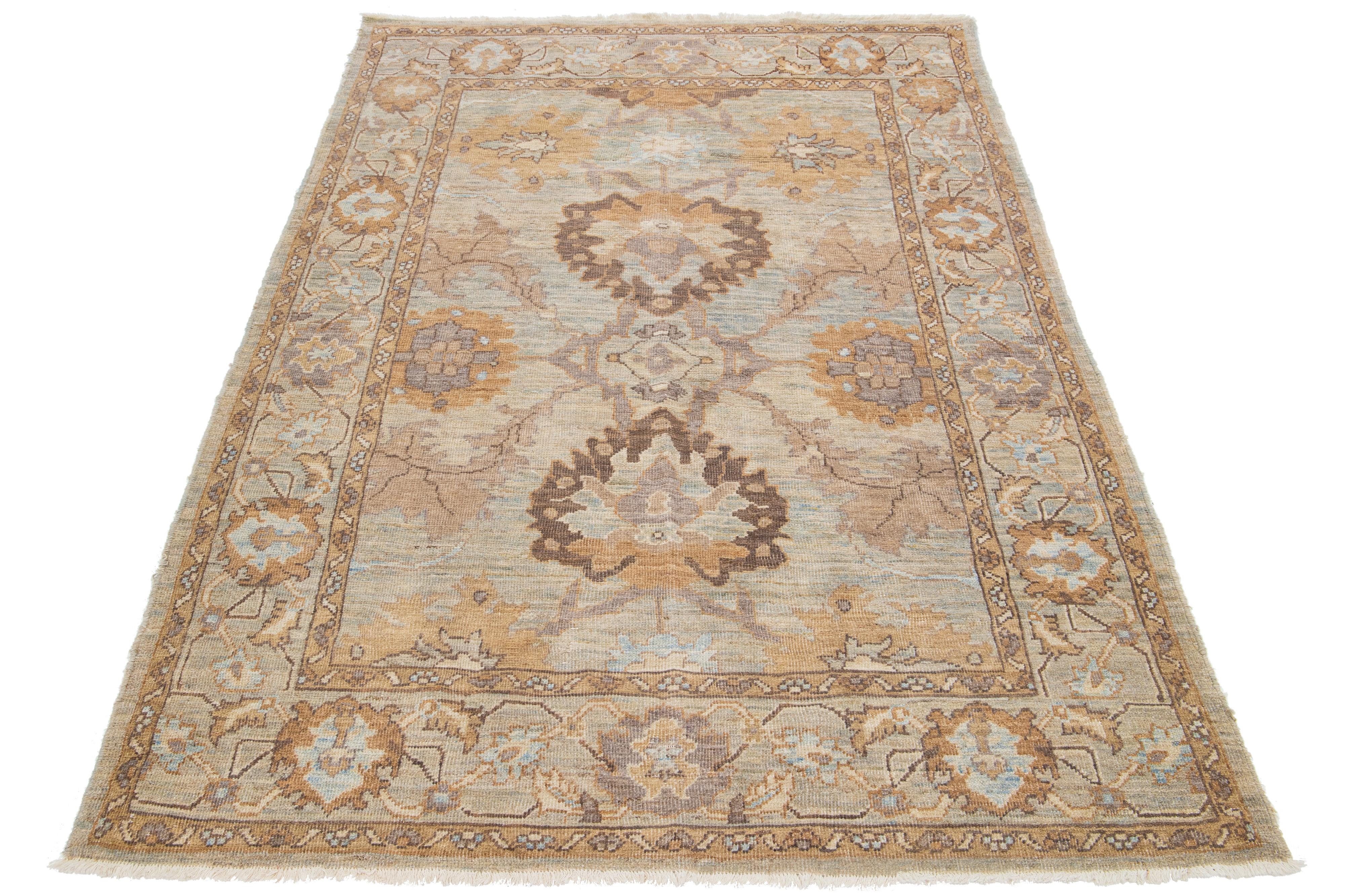A stunning hand-knotted Sultanabad rug featuring an all-over brown field adorned with light blue, beige, and gray accents.

This rug measures at 5'1