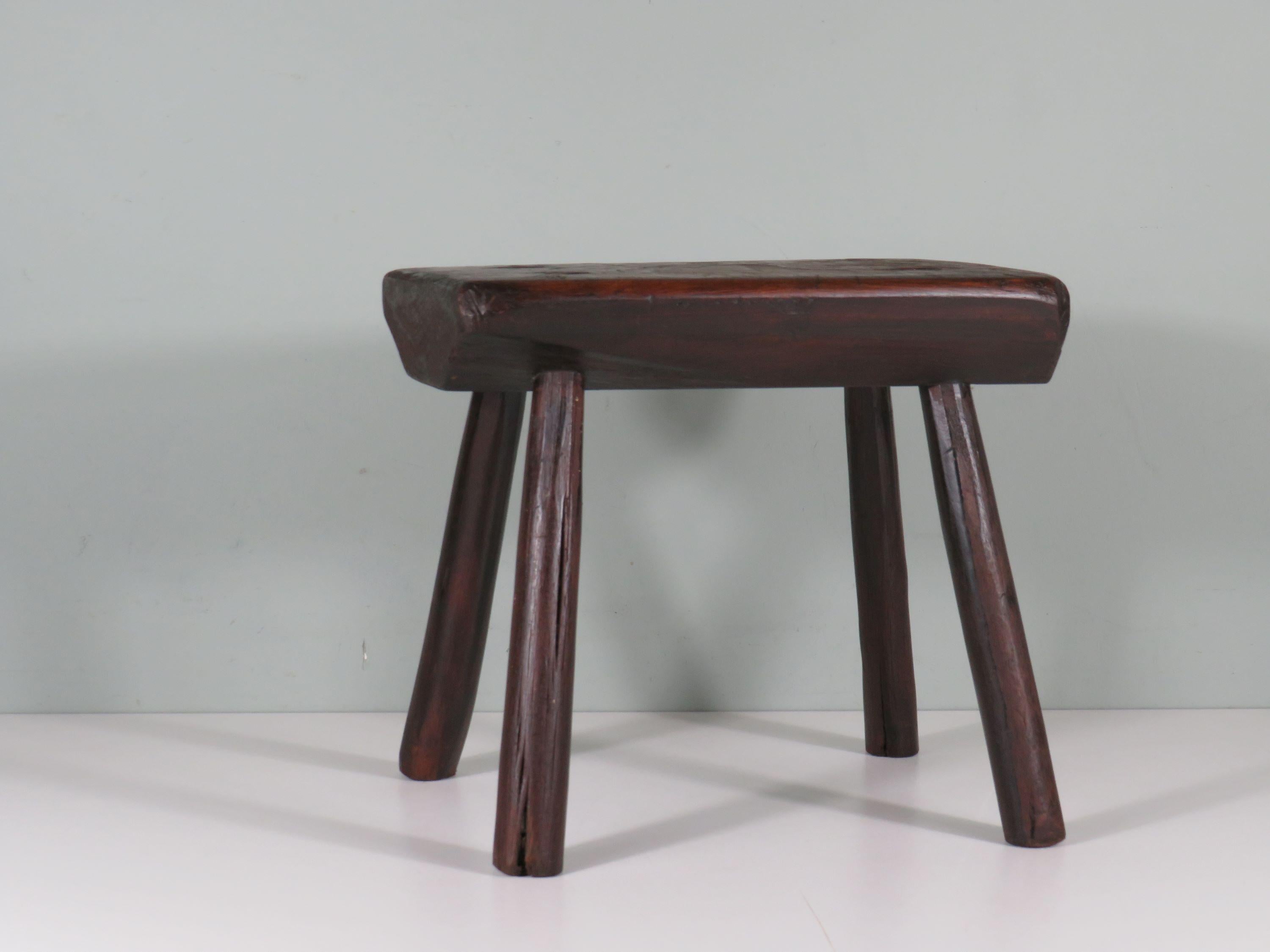 Mid century French low rectangular stool in dark oak with round legs that diverge downwards.
The handmade stool has a beautiful patina and is in sturdy condition.
The seat height of the stool is 32 cm, the seat measures 36 cm by 20 cm.