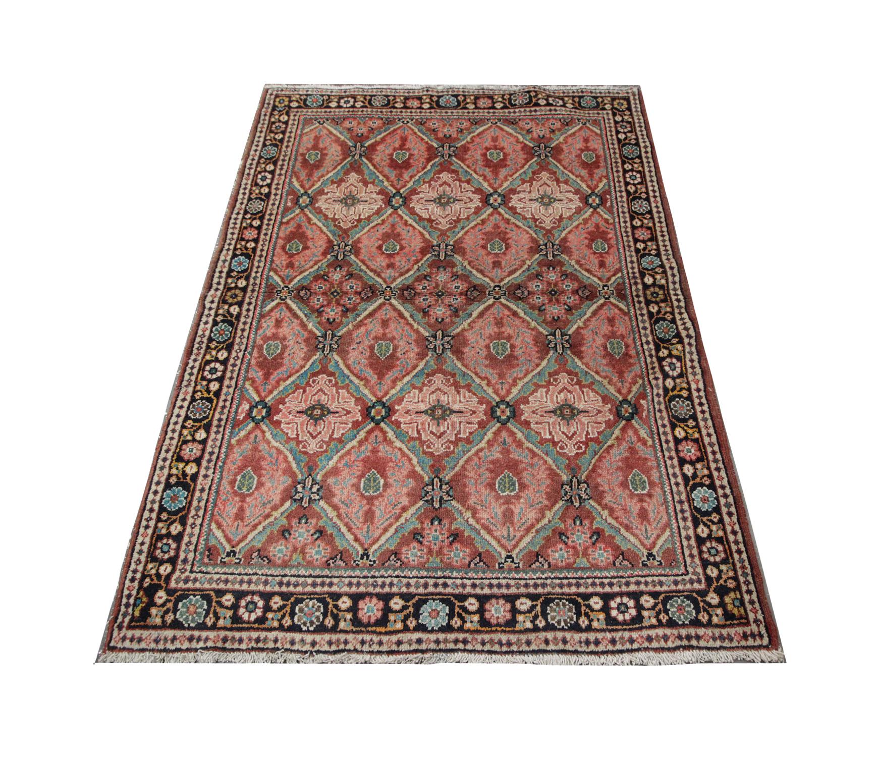 Bright pink, red and green tones cover this Oriental rug in the all-over repeat pattern. The intricate design reveals diamonds woven with detail, this is enclosed by a floral motif border. This handmade carpet is then finished with a fringe detail