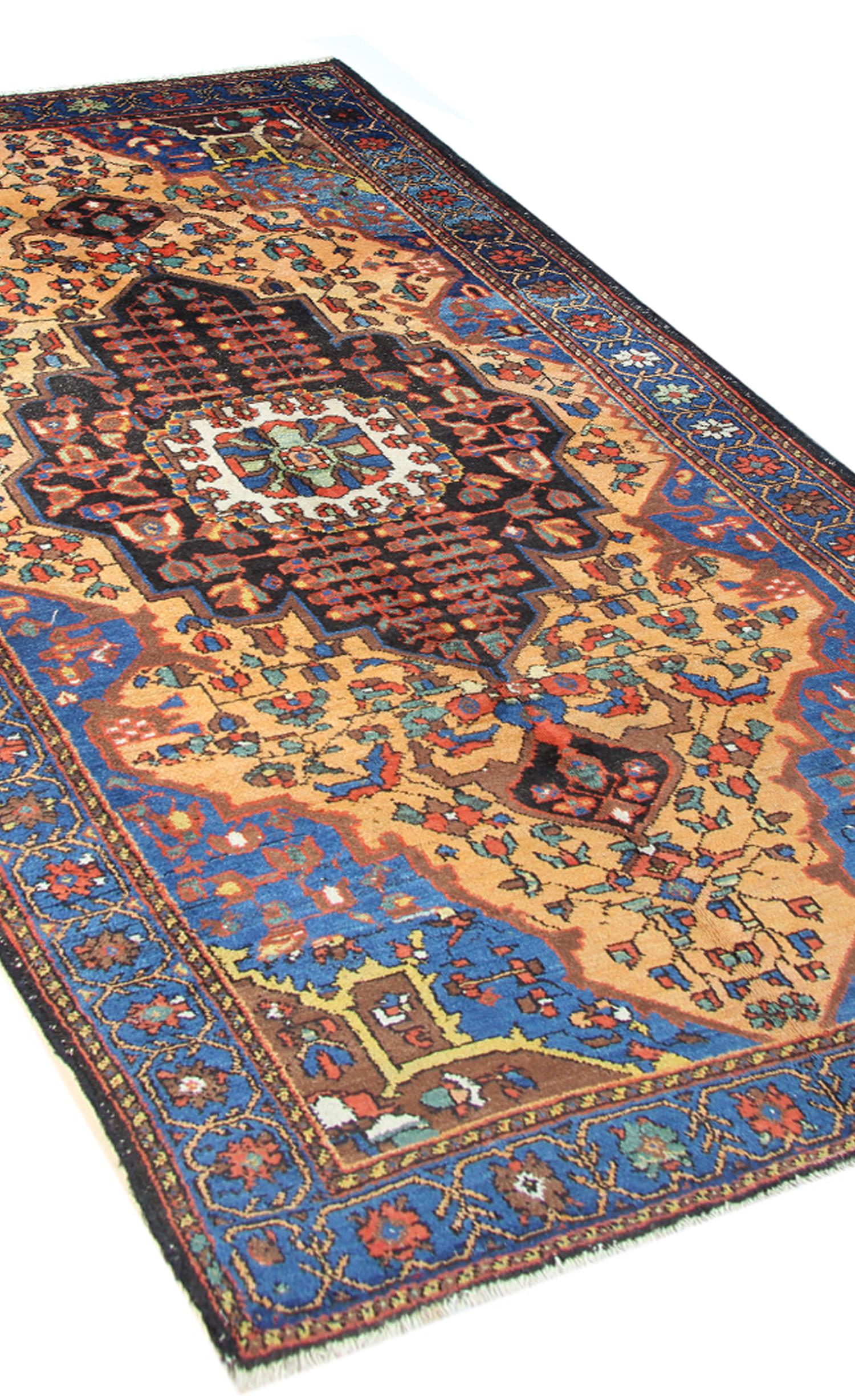 This beautiful Antique area rug is in excellent condition with a highly detailed central medallion design woven on a gold background colour which complements the navy blue colour in the four corners of the rug and the medallion. Suitable for use as