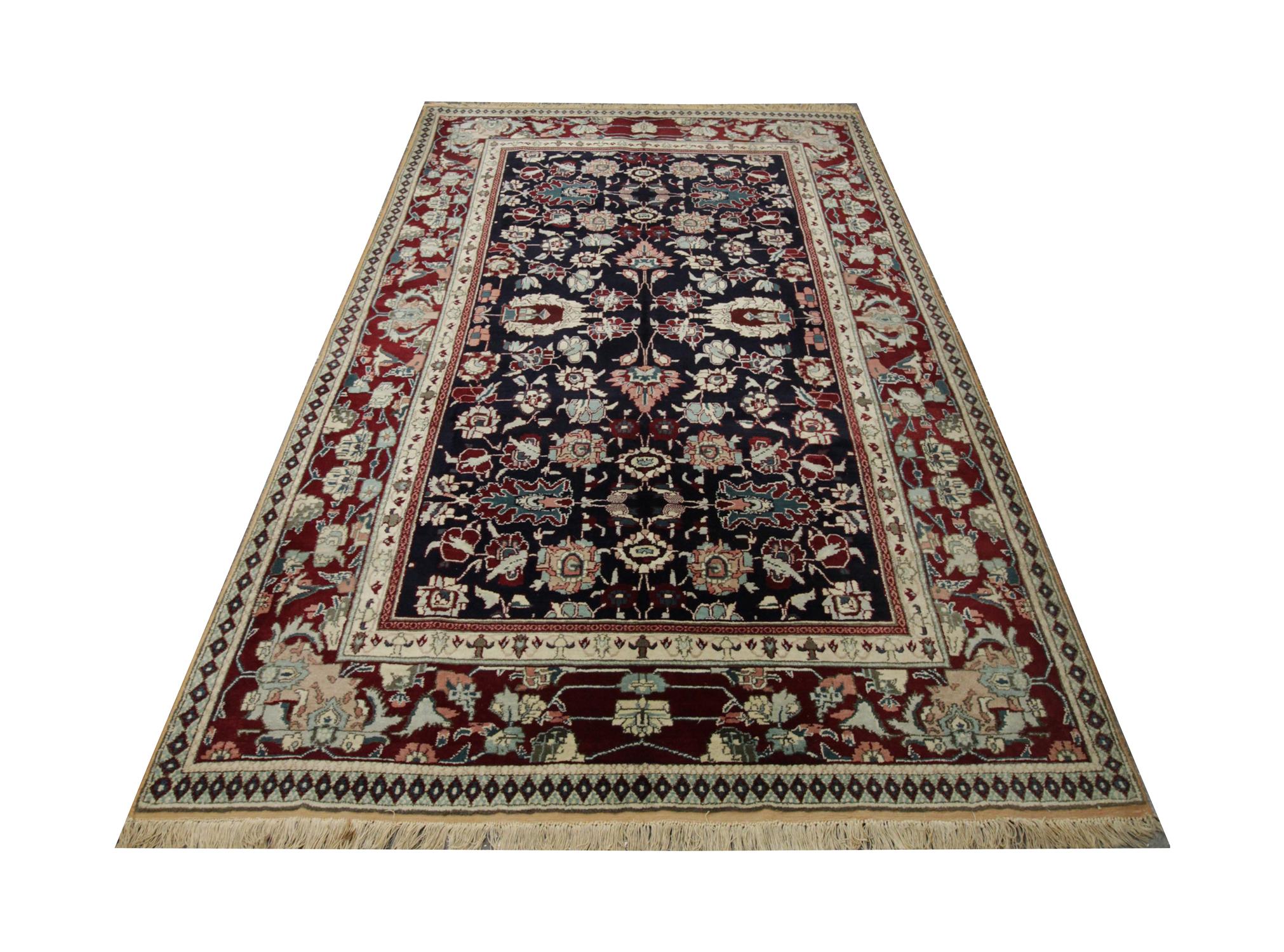 This elegant wool rug was woven by hand in India in the 1900s. Constructed with a fantastic design and colour palette including blue, brown and beige. The tribal patterns have been intricately designed with motifs and medallions symmetrically
