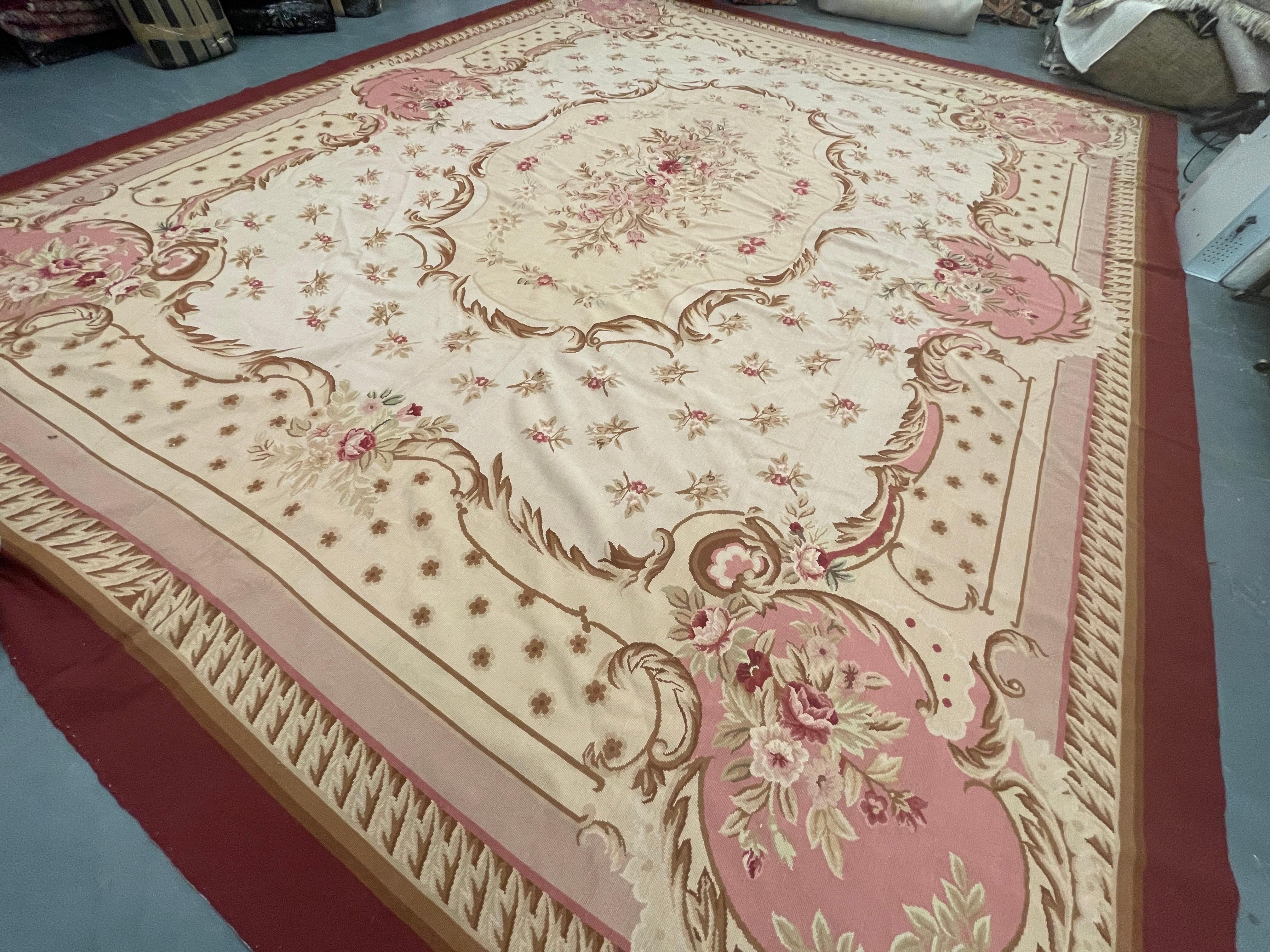 Featuring intricately woven motifs and emblems on a mixture of beige and pink backgrounds through the centre. A highly detailed layered border then encloses the handmade Aubusson carpet.
This high-quality French Aubusson rug is perfect for modern