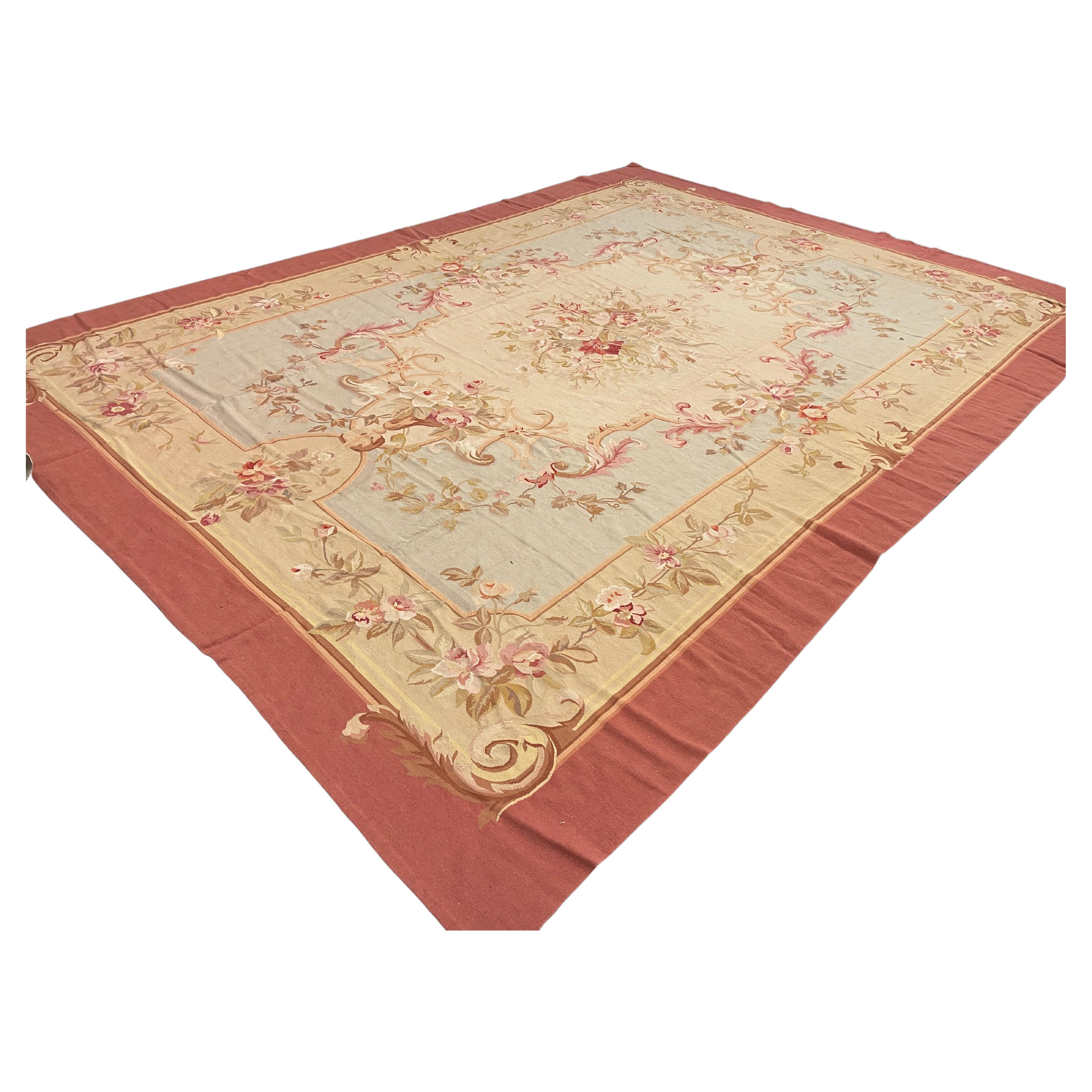 Featuring intricately woven motifs and emblems on a mixture of beige and light blue backgrounds through the centre. A highly detailed layered blush pink border encloses the handmade carpet for your elegant home decor.
This high-quality French