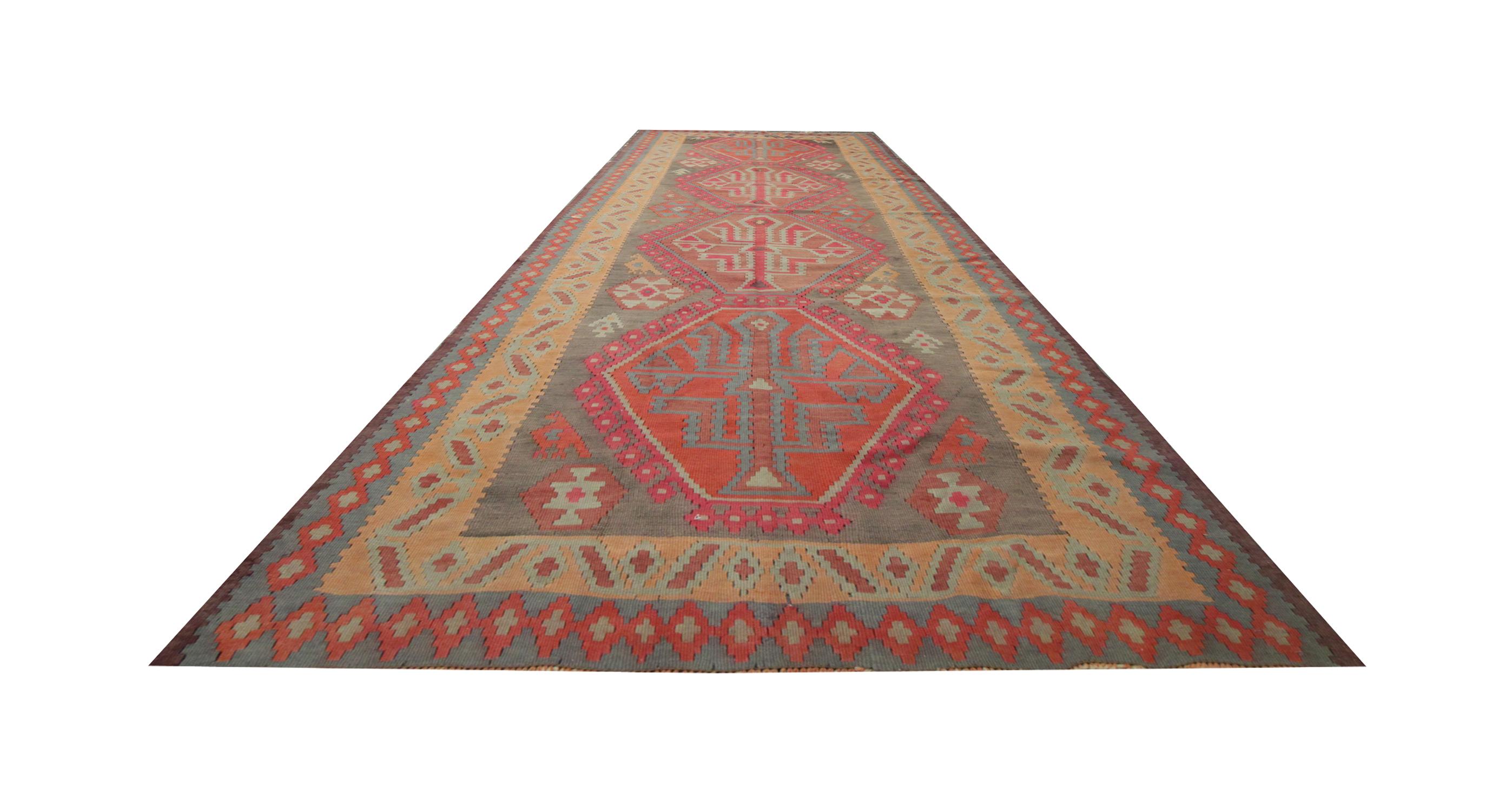 This fine wool rug is a handwoven Caucasian Kilim rug. Tones of red, orange, green and yellow marry together to form this beautiful geometric design, with symbolic details drawn from nature, leaves and animals. The colours and patterns in this rug