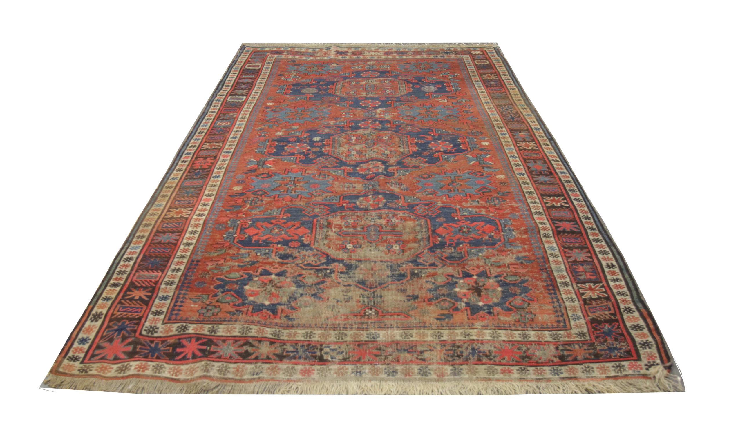 Featuring red and blue colorways in a geometric repeat central design which is enclosed by a triple layer highly detailed border. This high-quality area rug was hand knotted in the 1880s with hand-spun, vegetable-dyed wool and cotton, by some of the