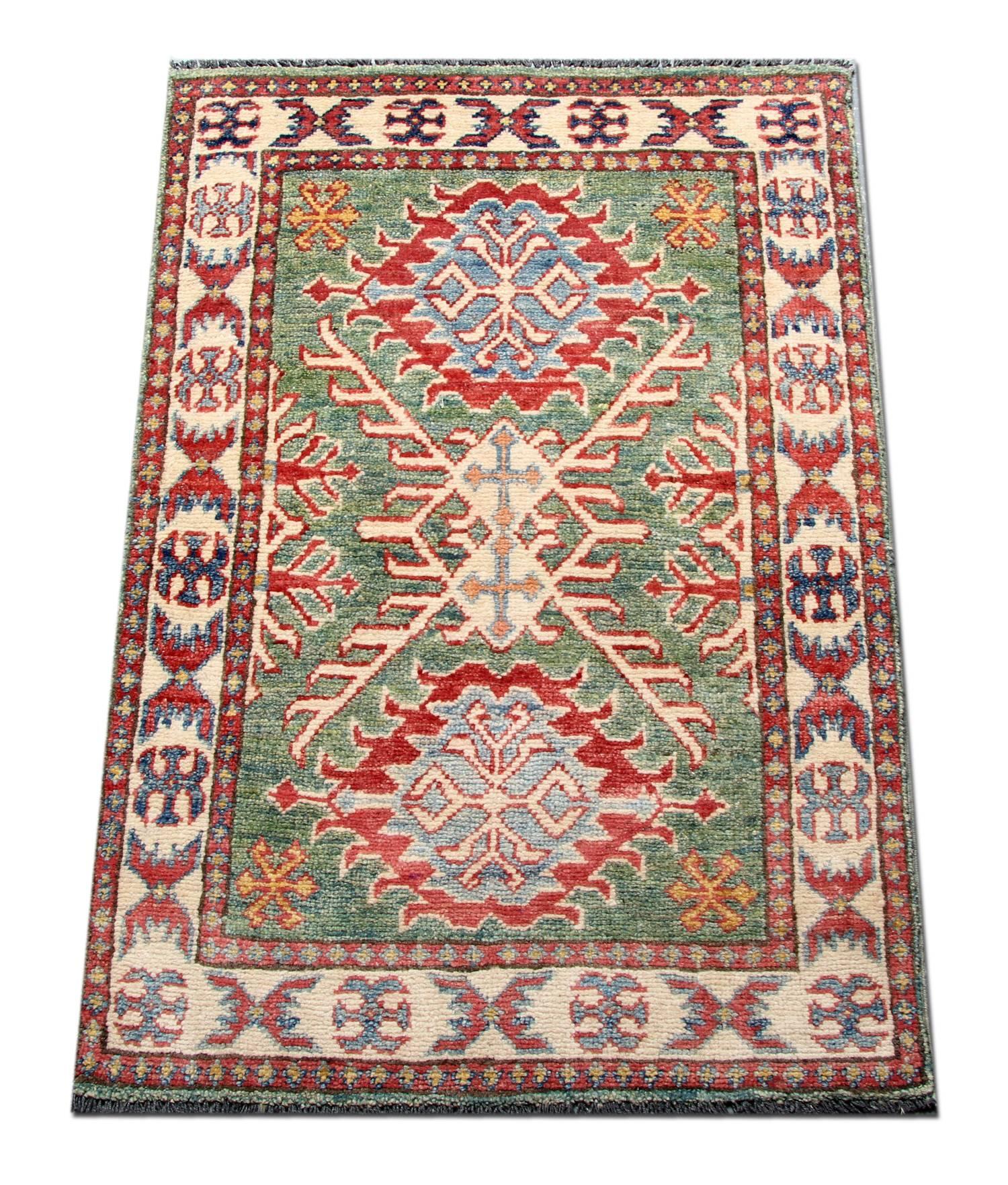 A beautiful new traditional Afghan Kazak rug, featuring a traditional tribal medallion design woven in accents of red, Green, and cream, through the centre on an aqua blue field. The design is then finished with a highly-detailed repeat pattern