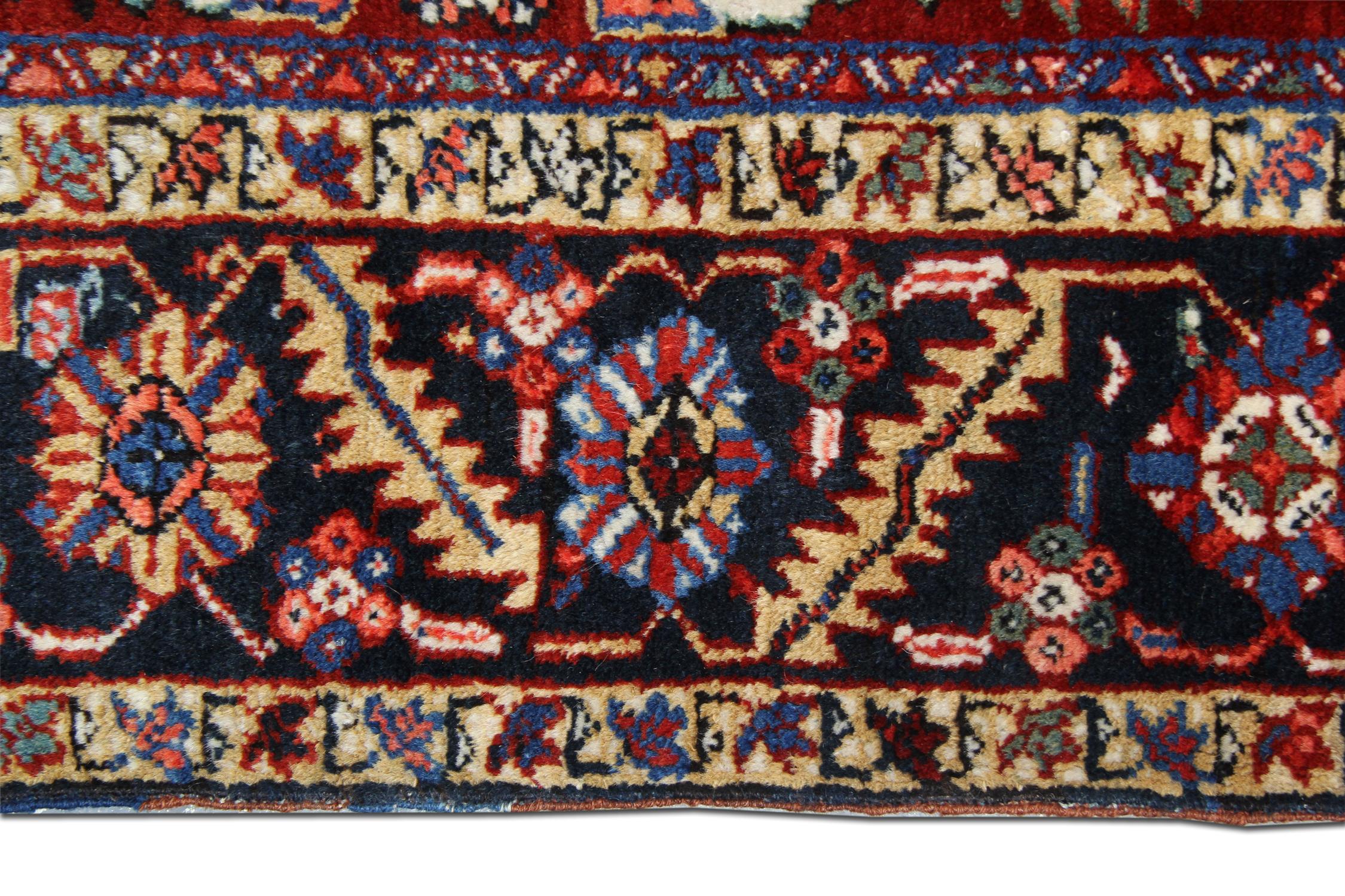Second hand Antique rugs are great accessories to uplift a dull space. This stylish carpet has been woven by hand with a rich deep red background and accents of yellow, orange, ivory and blue that make up the decorative, symmetrical tribal design.