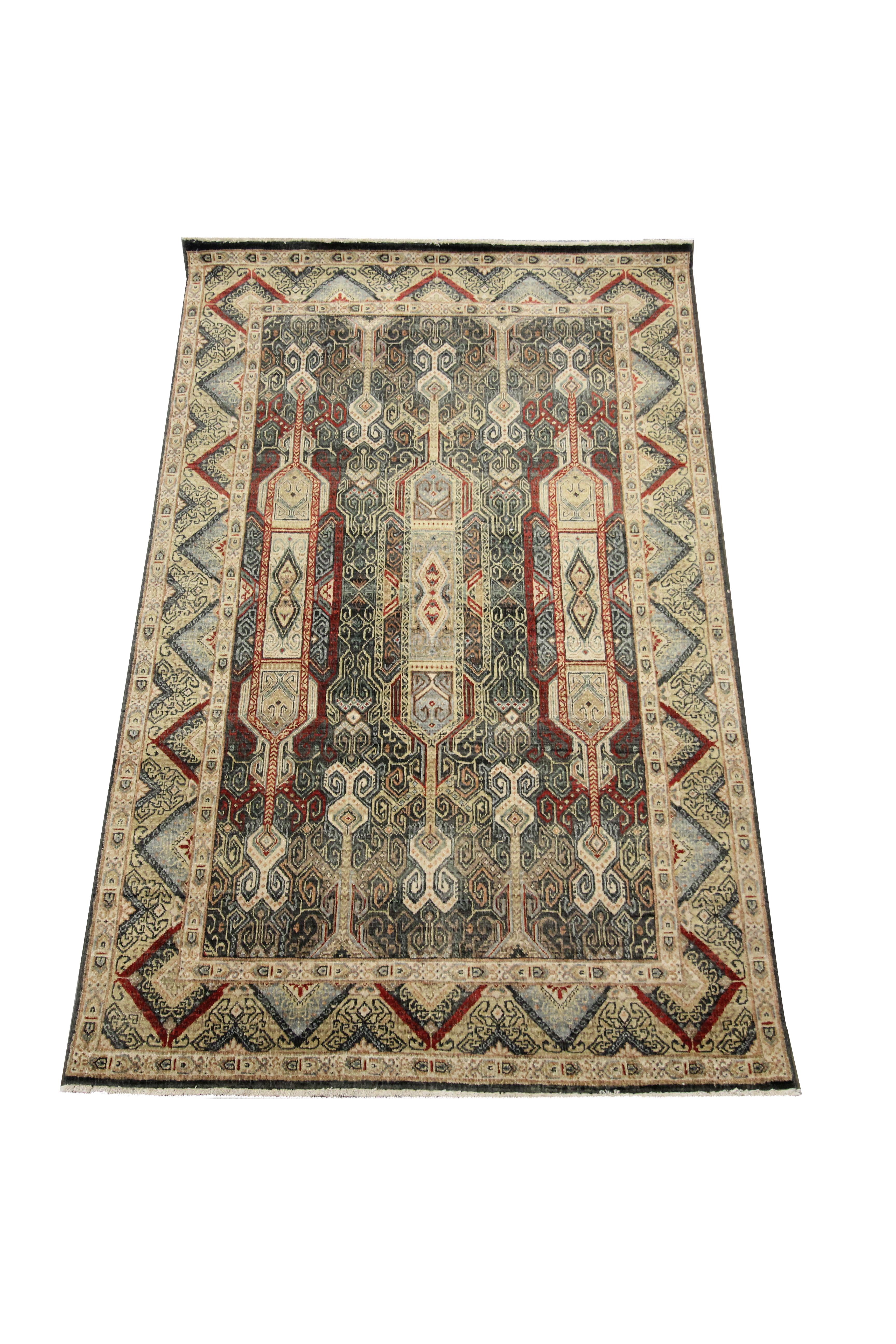 This traditional medallion carpet was woven by hand in India in the early 21st century. The design features a large red medallion woven with floral details throughout. Blue, brown and green accents then make up the decorative details and repeating