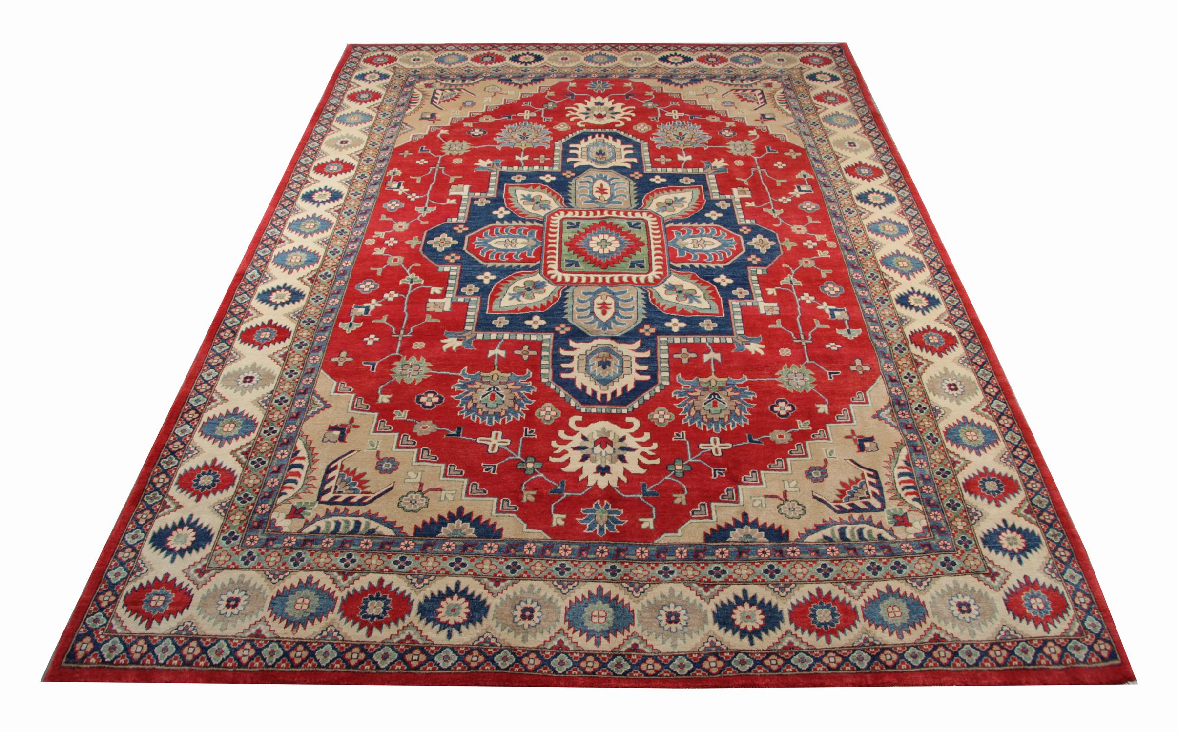 A beautiful new traditional Afghan Kazak rug features a conventional tribal medallion design woven in beige, blue and green accents through the centre on a red field. The design is then finished with a highly-detailed repeat pattern border that