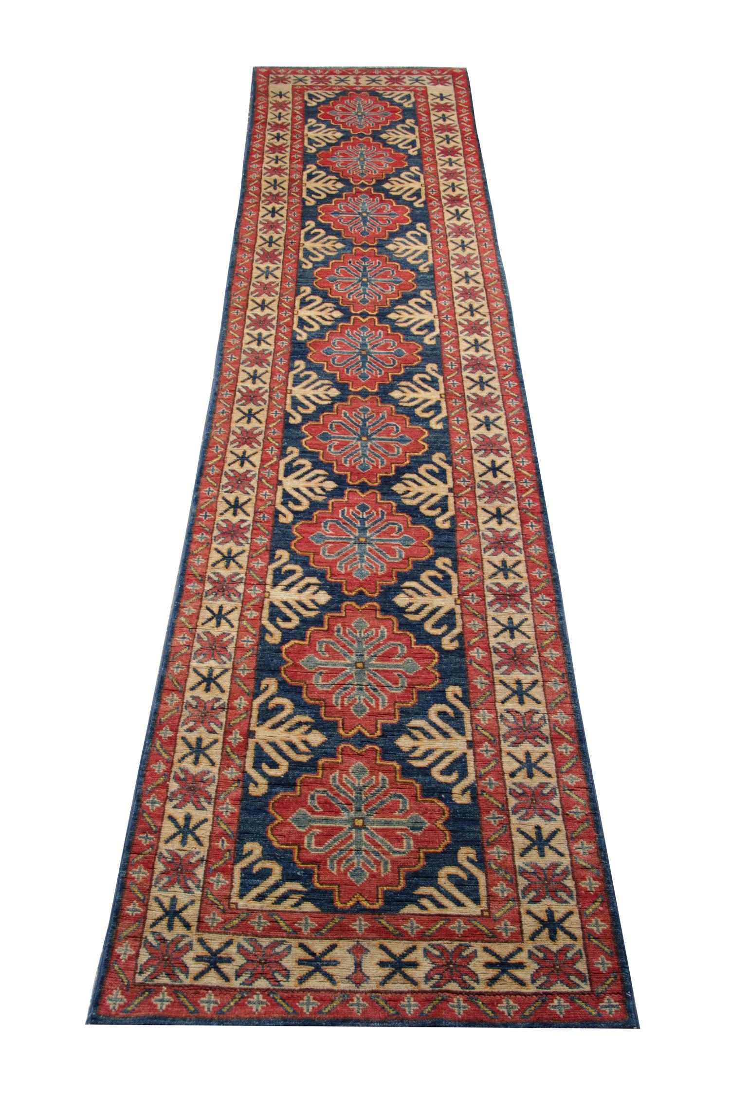 A beautiful new traditional Afghan Kazak runner rug featuring a conventional tribal medallion design woven in accents of red and cream, through the center on an aqua blue field. The design is then finished with a highly-detailed repeat pattern