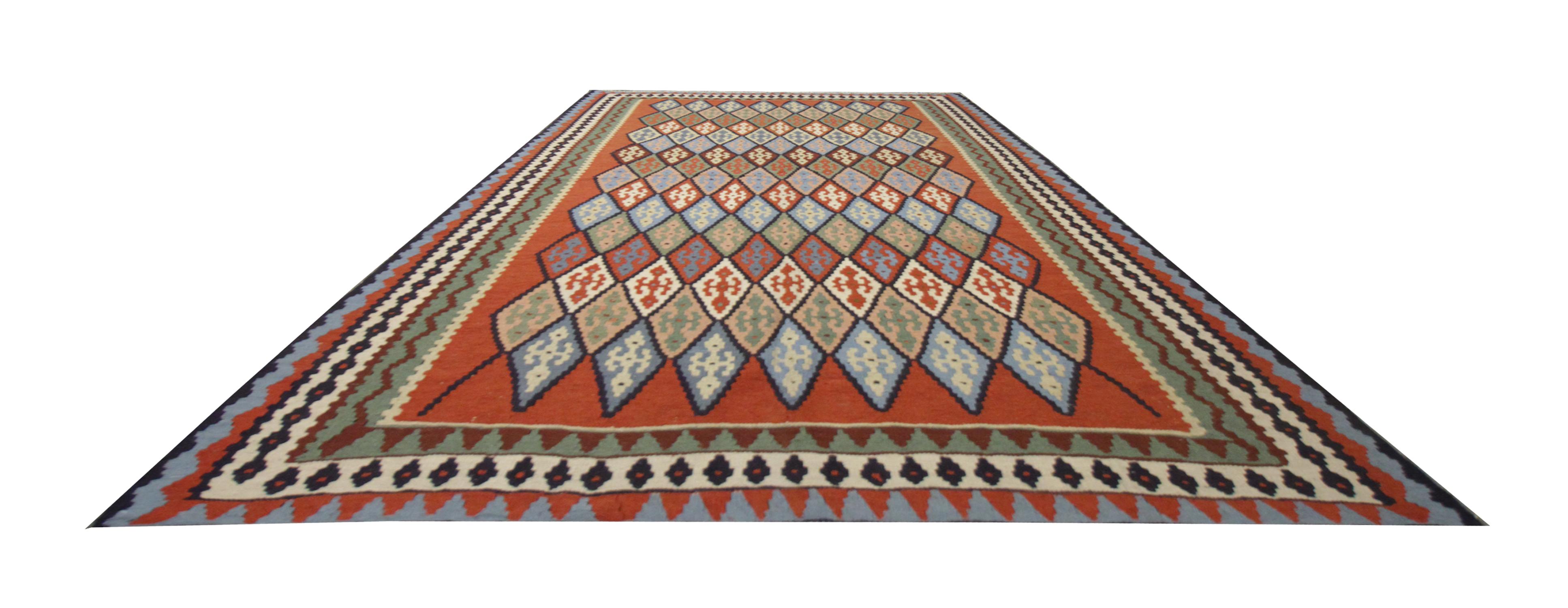 This elegant handwoven wool area rug was constructed in the late 20th century around 1980 in Turkey. The design features cream, brown, blue, orange and rust colours that make up the fantastic elegant pattern tribal design. Both the colour and