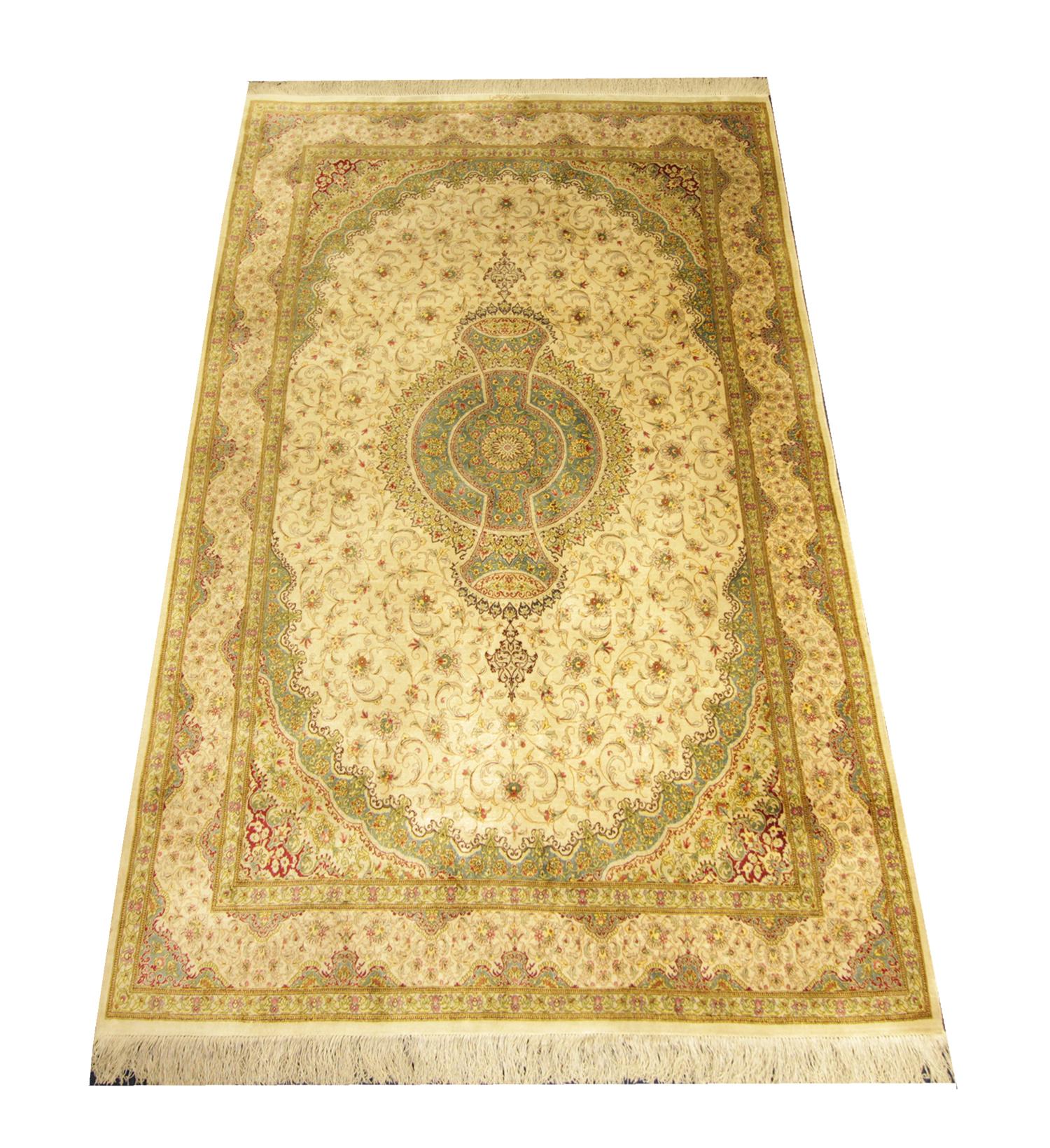 This fine Turkish silk rug was woven with the finest organic materials. The central design has been woven on a cream background with beige and green accents that make up the symmetrical flowing floral medallion design. This fine oriental rug