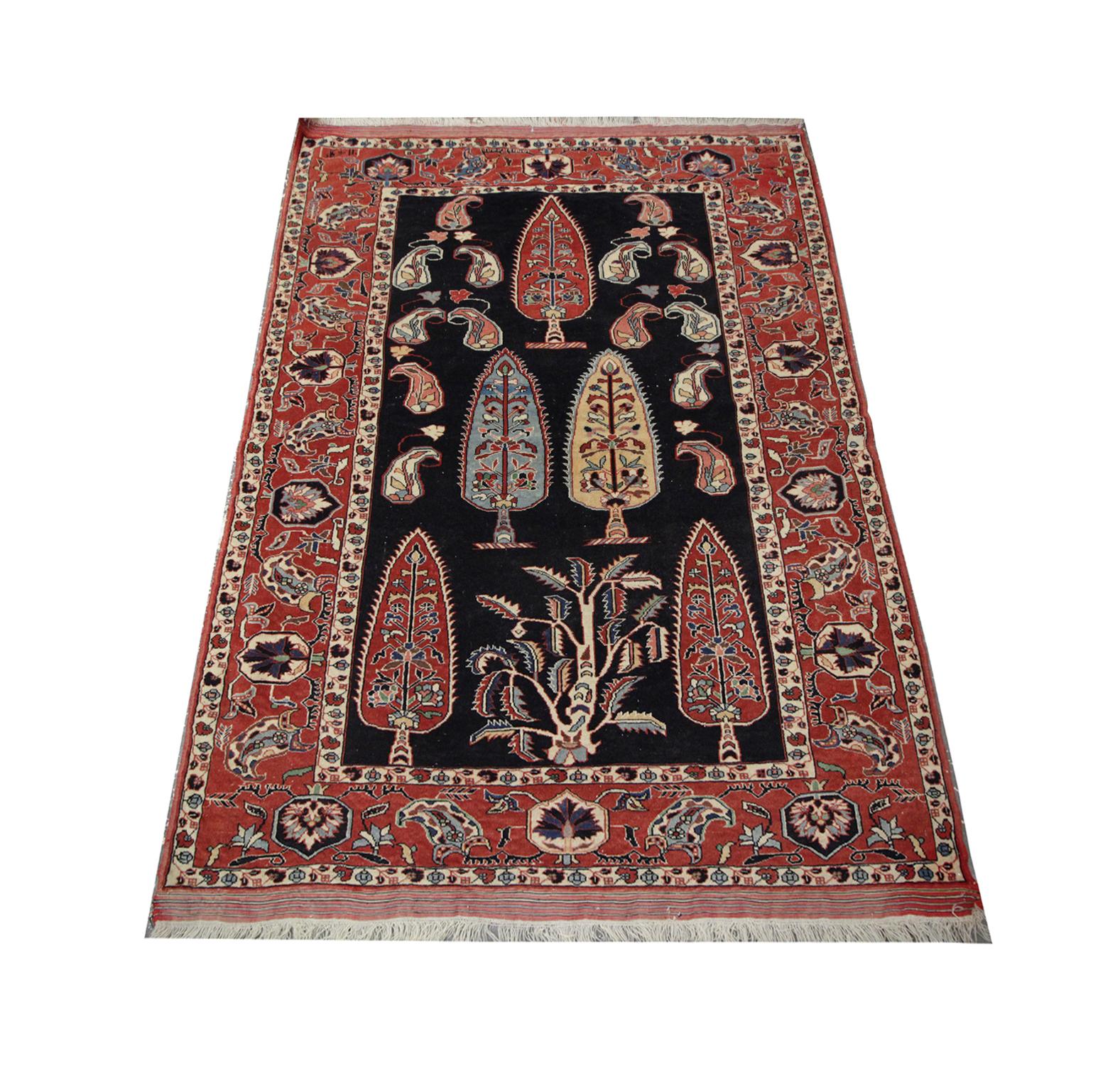 Handmade carpet with stunning Reds drench this vintage Caucasian, Azerbaijan area rug, featuring an abstract central design with yellow blue and red tree-like emblems with intricate details and surrounding tear-shaped motifs woven with floral