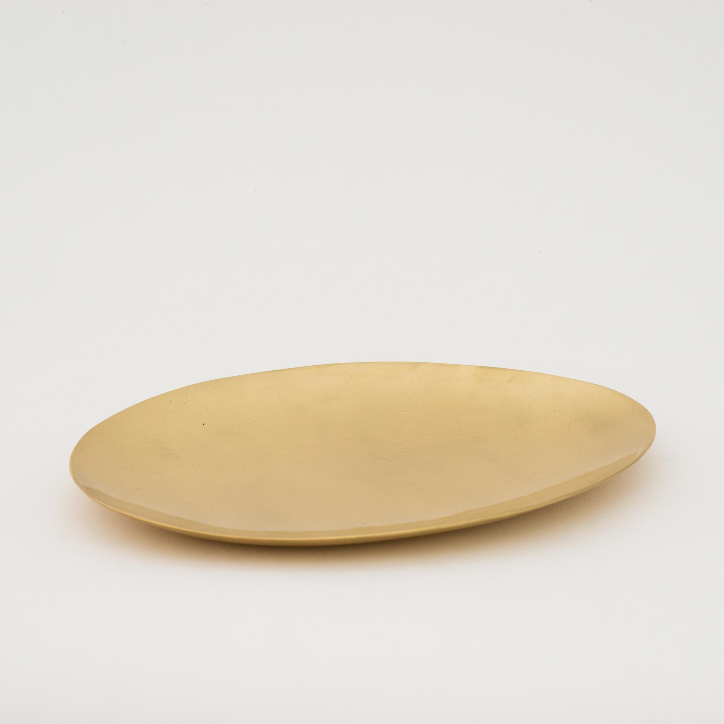 Set of three elegant handmade brass plates. Cast using very traditional techniques, their brushed matt finish makes them very elegant.

Very charming as decorative objects, they also work very well as plates for pillar candles.

Slight variations in