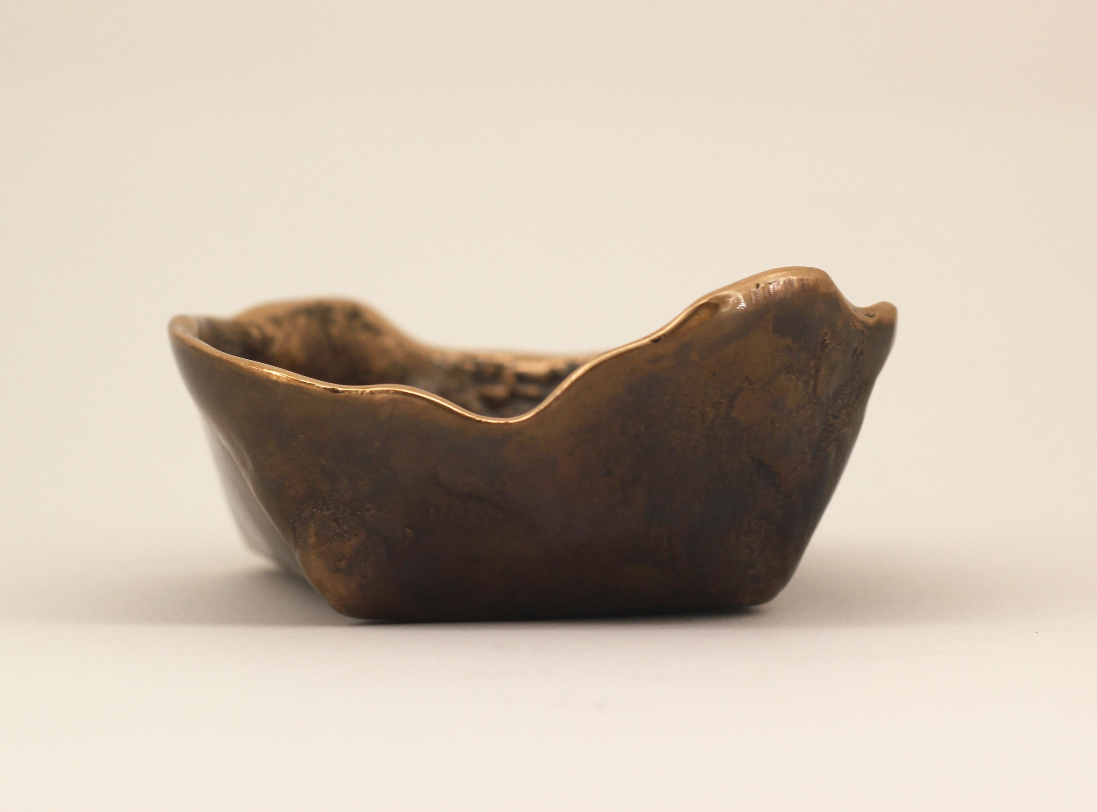 Graceful bronze bowl, vide-poche, inspired by Wabi-Sabi, the ancient Japanese philosophy that views and embraces the world for its imperfections and transient nature. It translates into an exquisite aesthetic that is imperfect and incomplete, yet