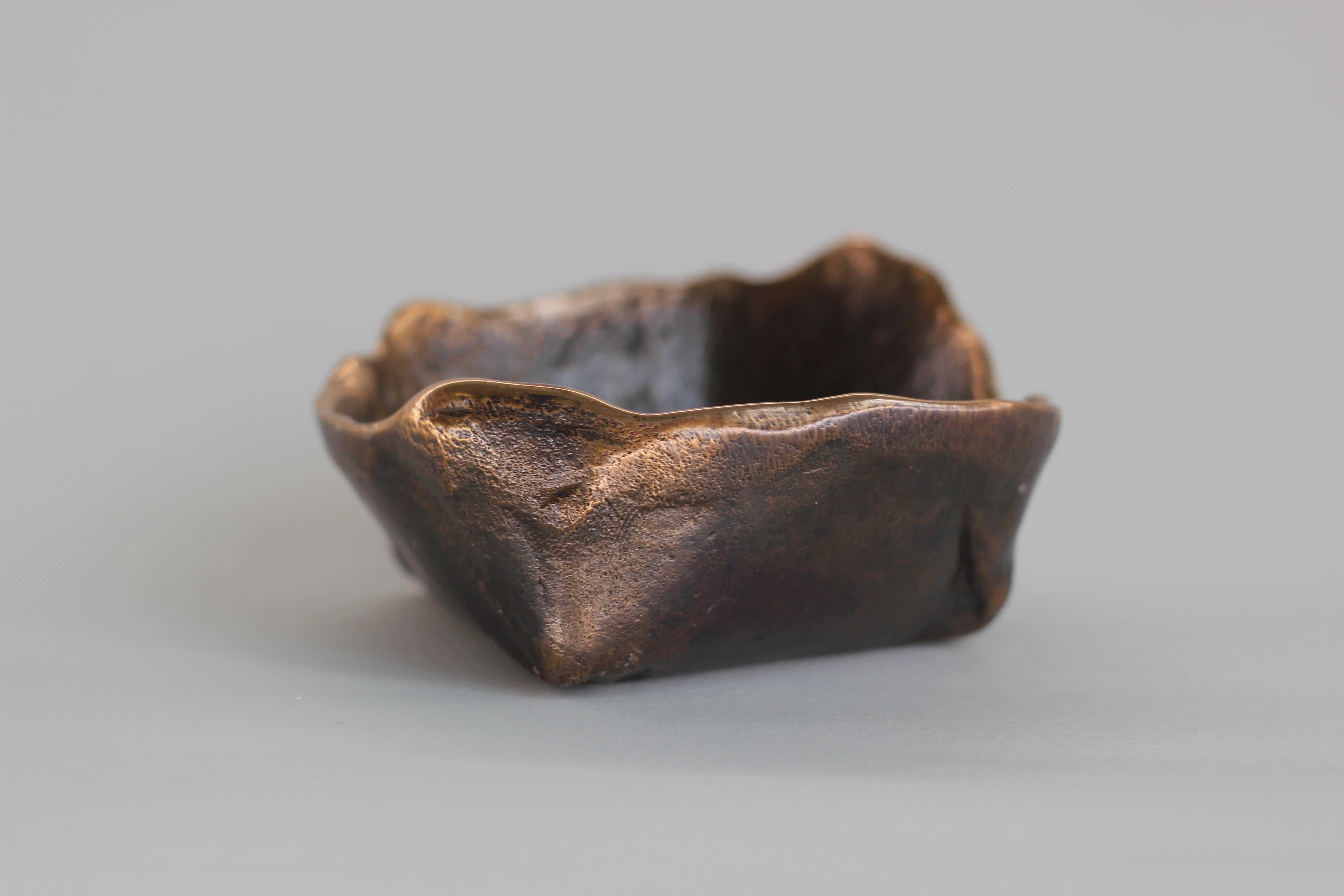 Graceful bronze bowl, vide-poche, inspired by Wabi-Sabi, the ancient Japanese philosophy that views and embraces the world for its imperfections and transient nature. It translates into an exquisite aesthetic that is imperfect and incomplete, yet