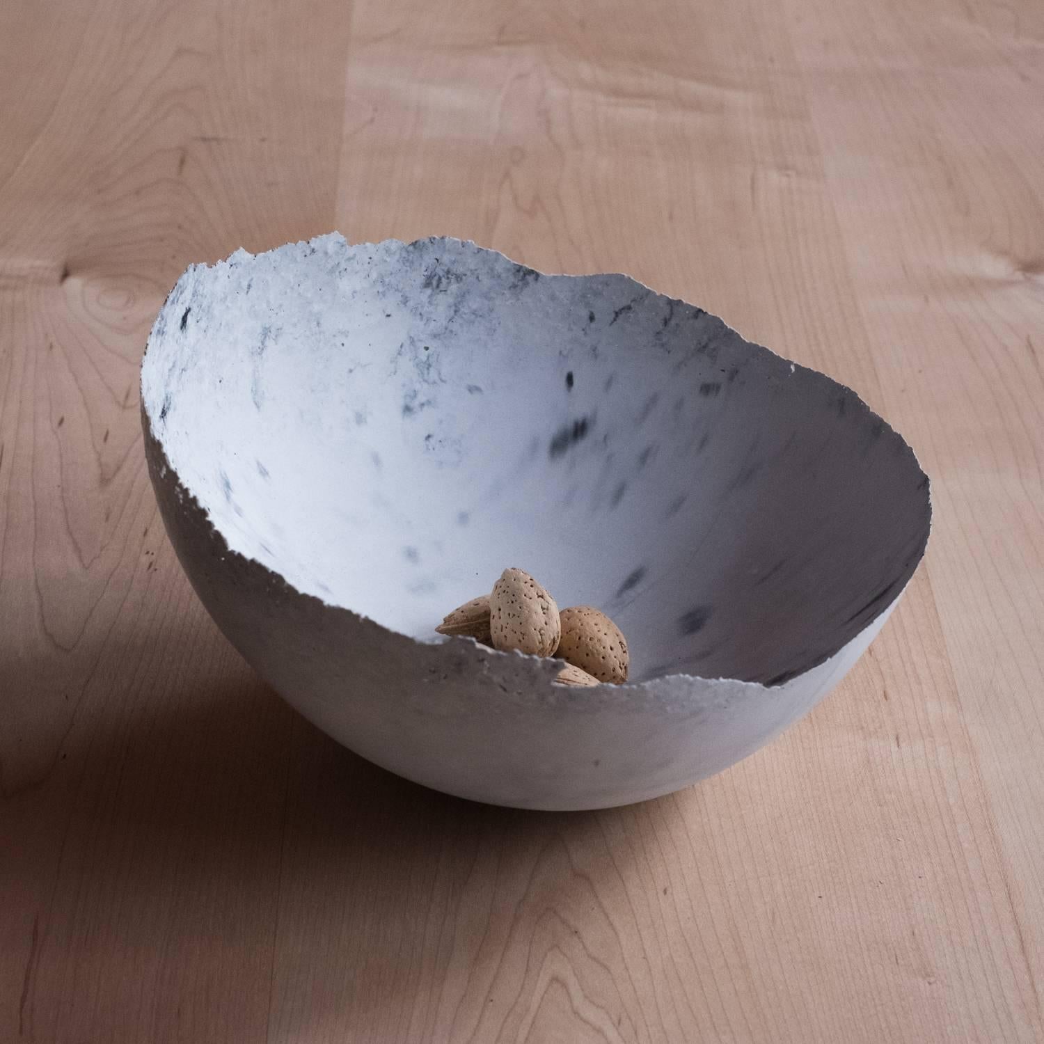 A collection of 236 unique bowls, the Concrete Series by UMÉ Studio expresses the tension between heavy concrete and its delicate edge generated by hand pouring. While one assumes concrete should be strong and durable, it is, at its core, fragile.