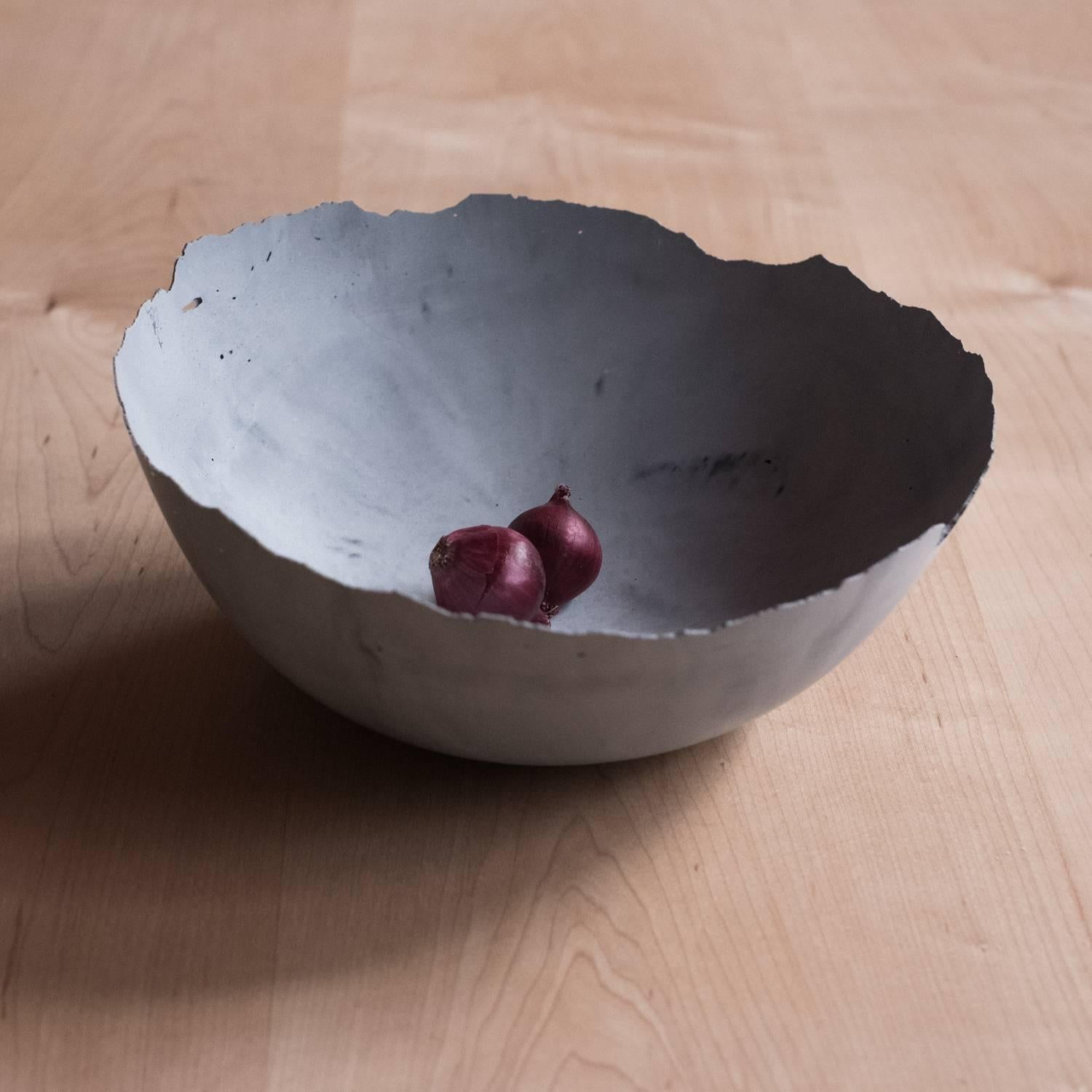 A collection of 236 unique bowls, the Concrete Series by UMÉ Studio expresses the tension between heavy concrete and its delicate edge generated by hand pouring. While one assumes concrete should be strong and durable, it is, at its core, fragile.