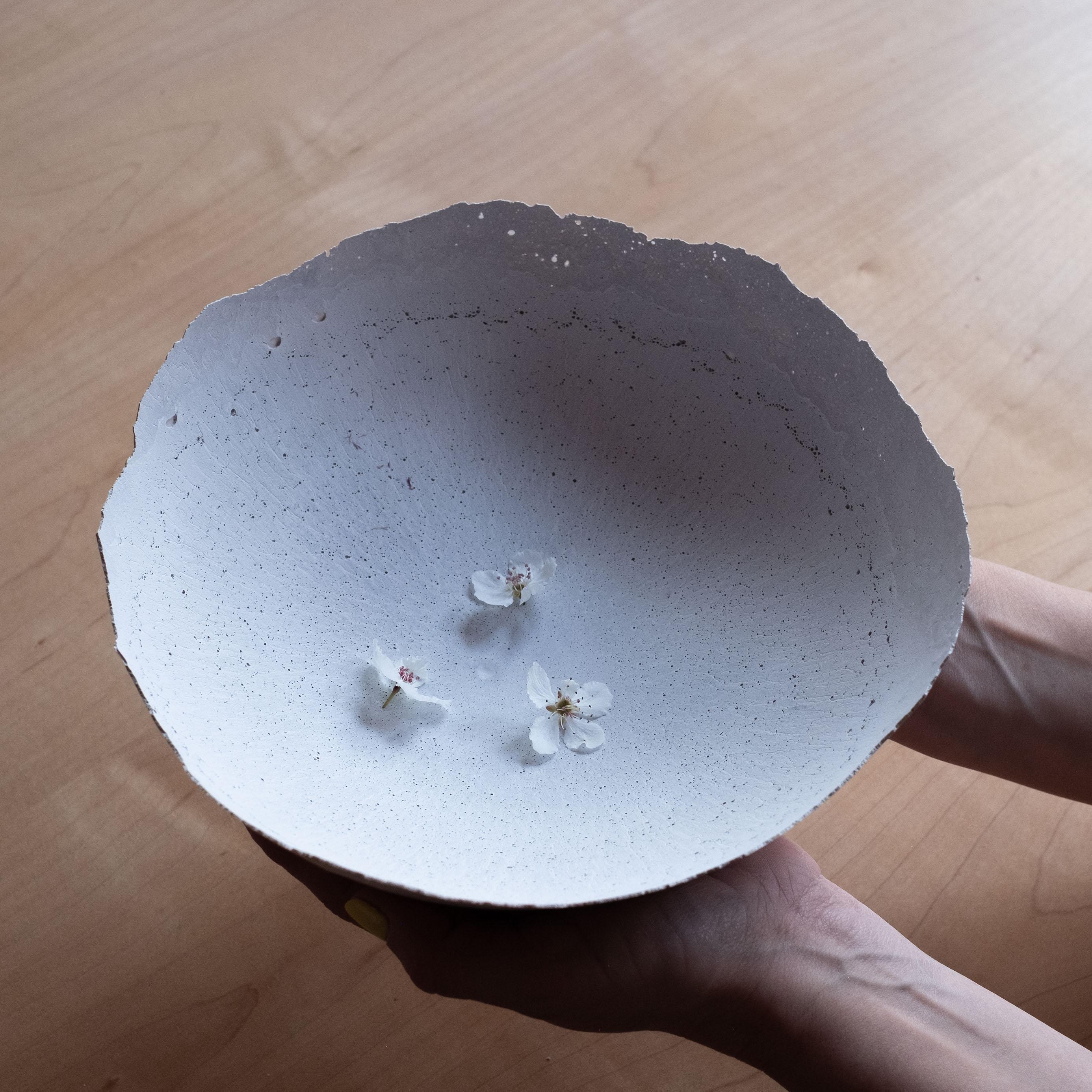 An edition of 150 unique bowls, the concrete Series by UMÉ Studio expresses the tension between heavy concrete and its delicate edge generated by hand pouring. While one assumes concrete should be strong and durable, it is, at its core, fragile.