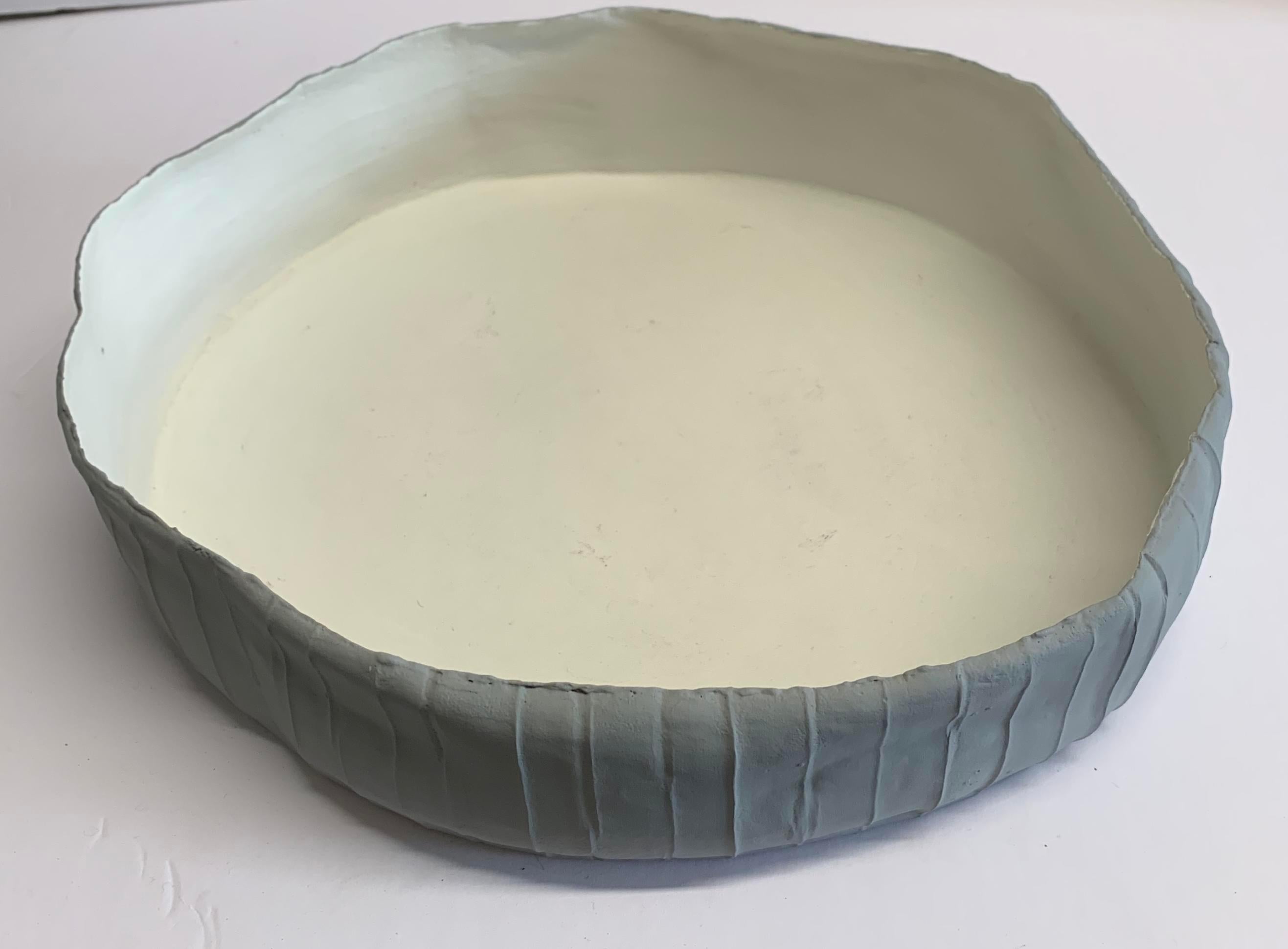 Contemporary Italian handmade fine ceramic bowl with pieced design grey colored apron and matte white interior.
