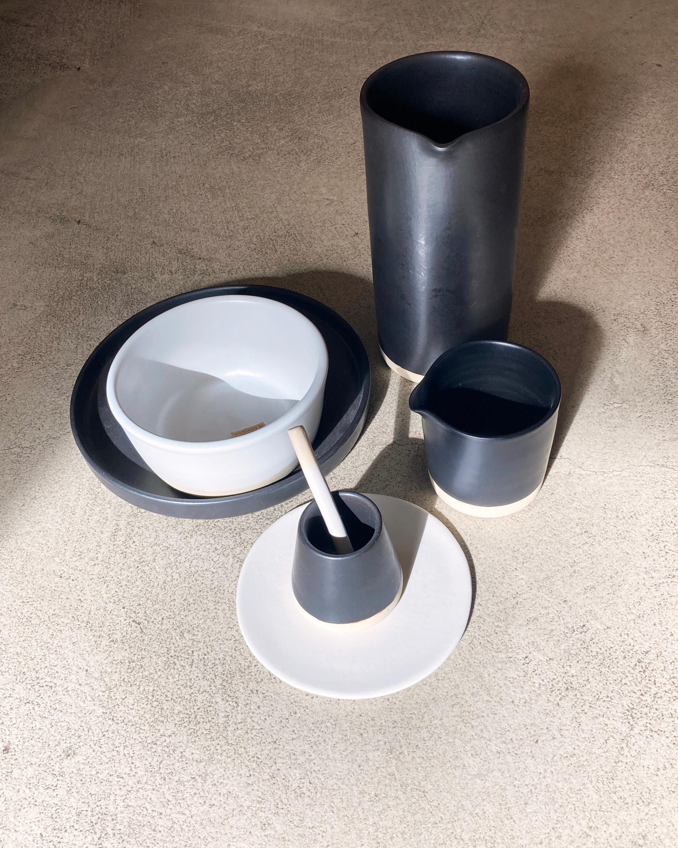 Handmade and hand painted ceramics from one of the mother countries, Portugal, these beautiful pieces for your table will add a modern touch and are perfect to mix and match. This matte-glazed cup is available in black or white.

Size: 2” height