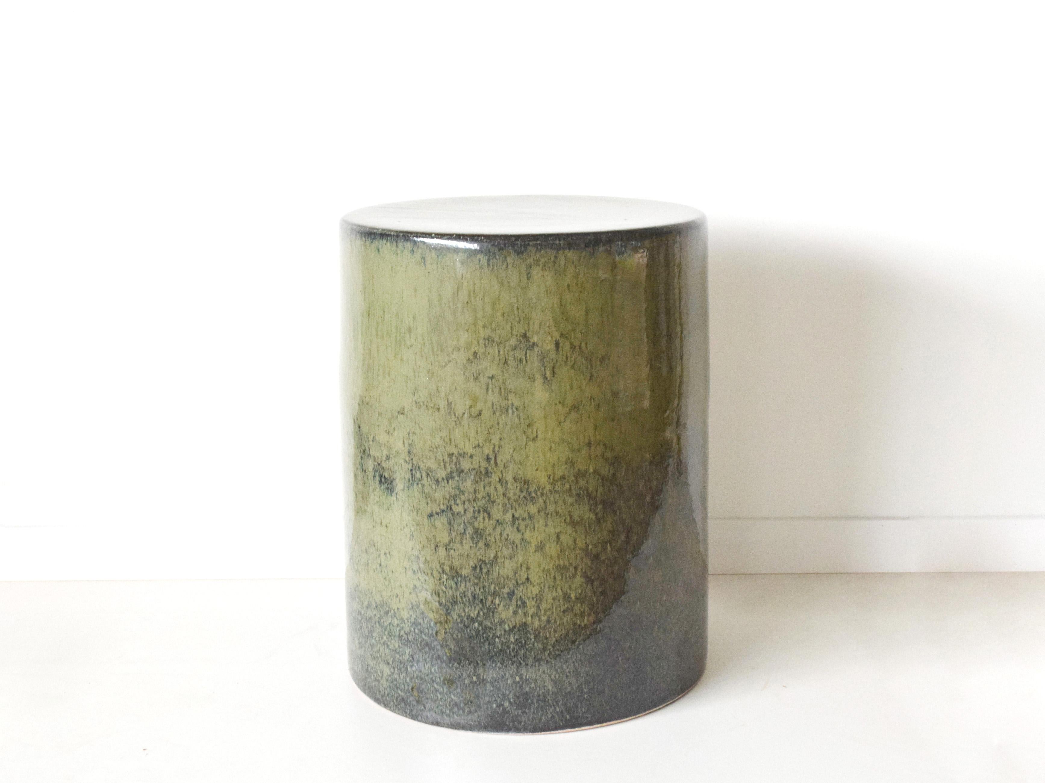 This versatile ceramic stool serves equally well as extra seating, a sculptural accent, or a functional side table. Its drum-like silhouette evokes timeless ceramic traditions while presenting a contemporary, minimalist character. Perfect for indoor