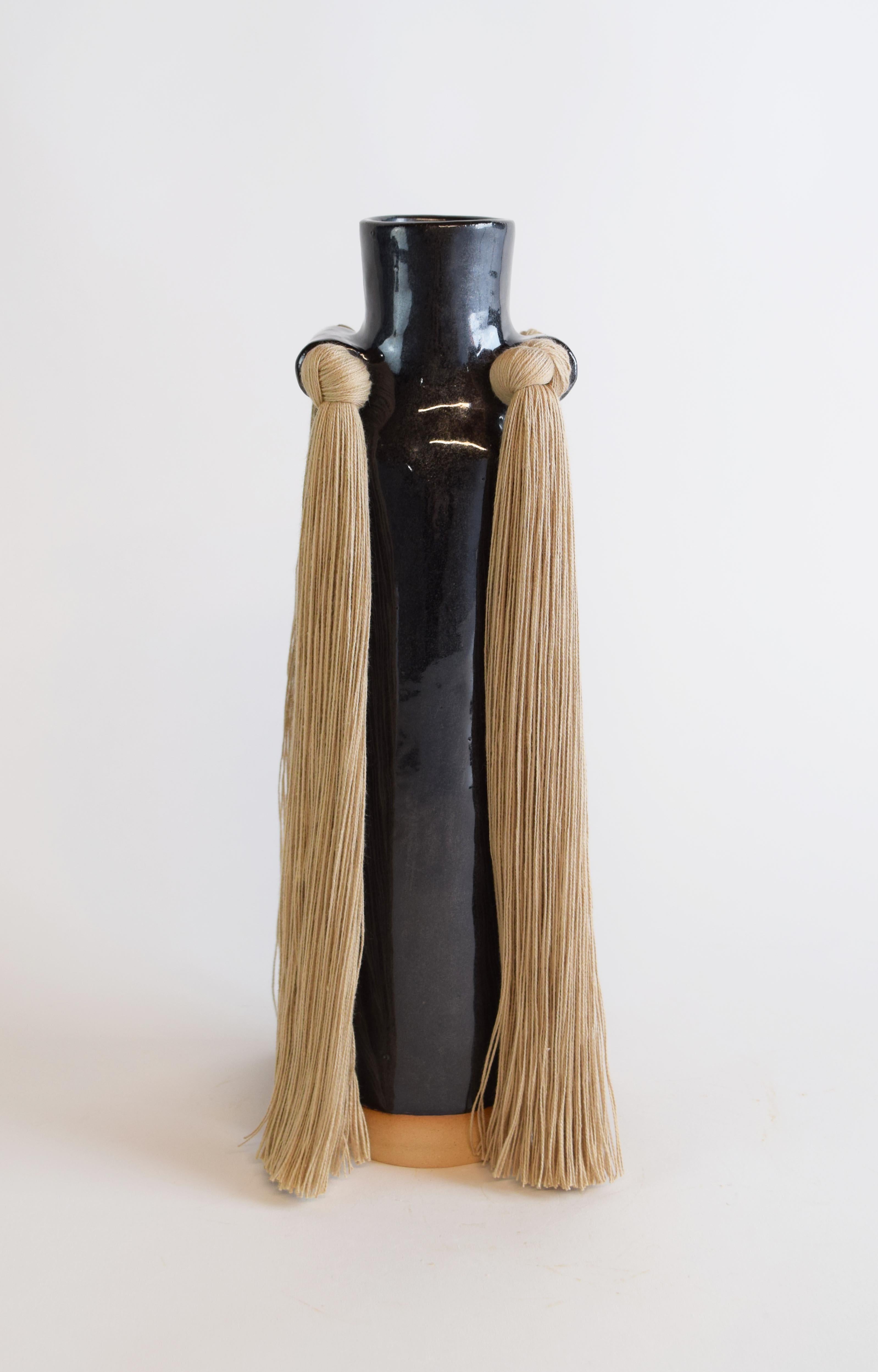 Vase #703 by Karen Gayle Tinney

Drawing on signature details from other Standard Collection pieces, this vase is an update to a traditional bottle neck silhouette. 

Hand formed beige stoneware with black glaze. Beige cotton fringe detail. Inside